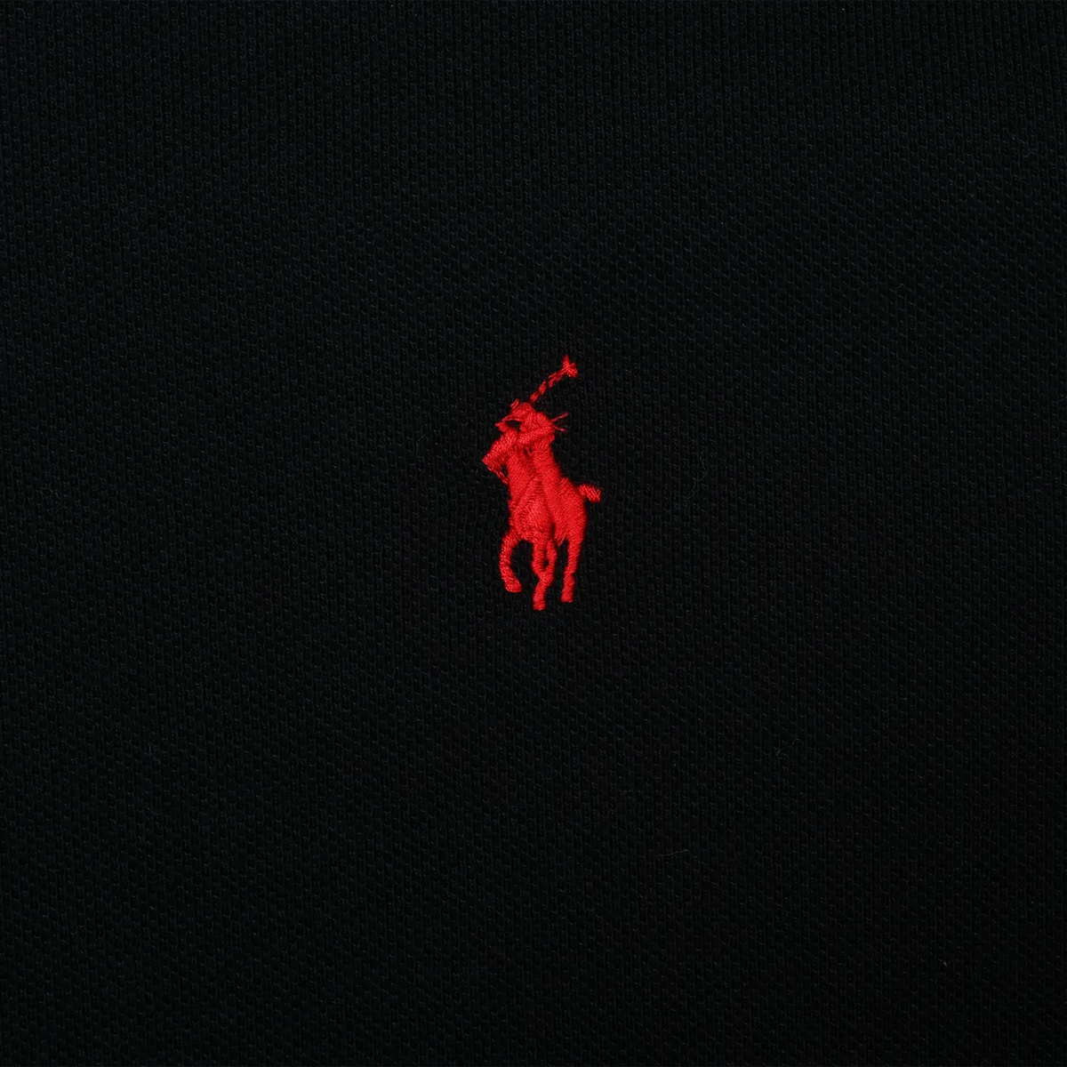 Close-up of red Polo Ralph Lauren pony embroidery on black fabric