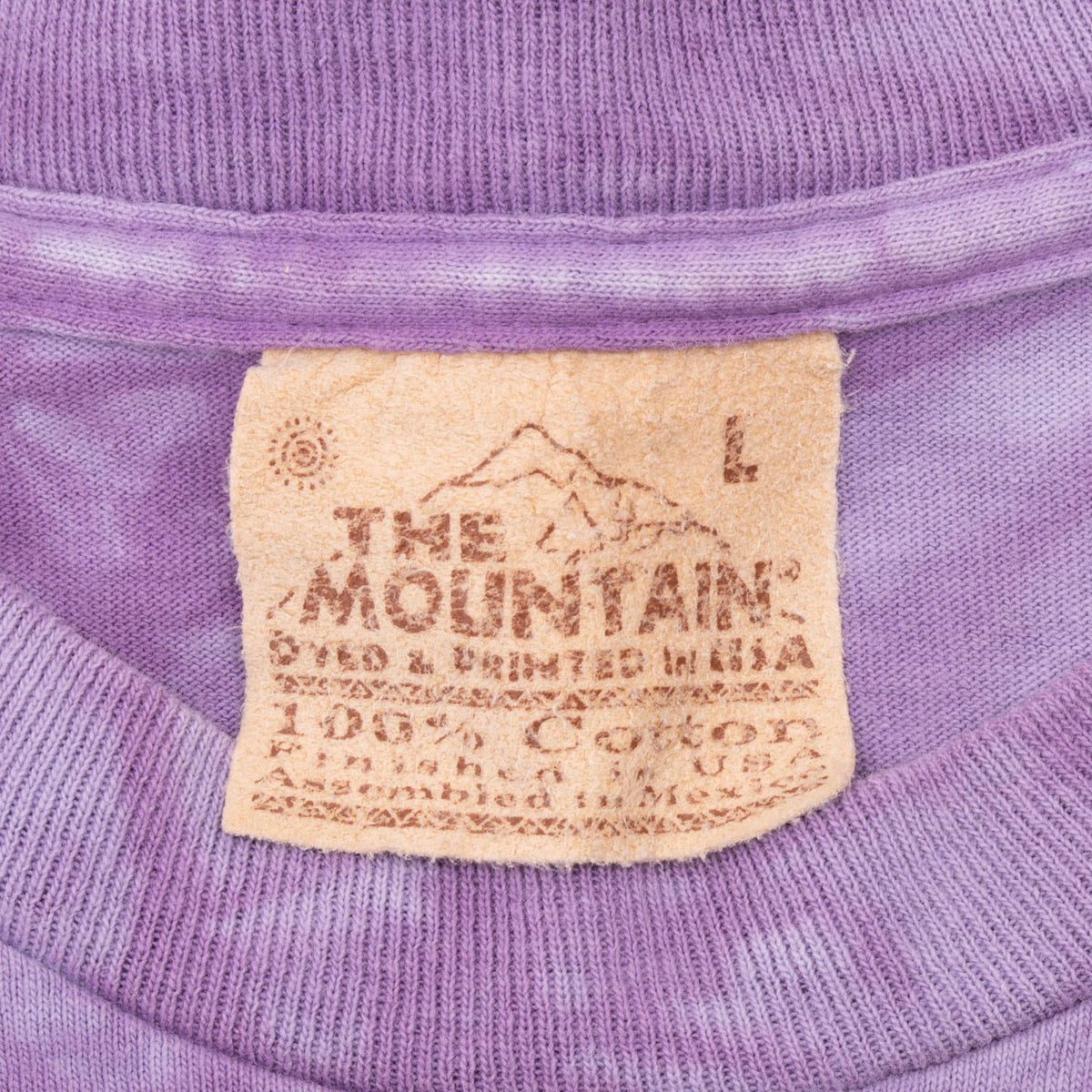 The Mountain neck label marked size large inside purple ribbed crew neckline