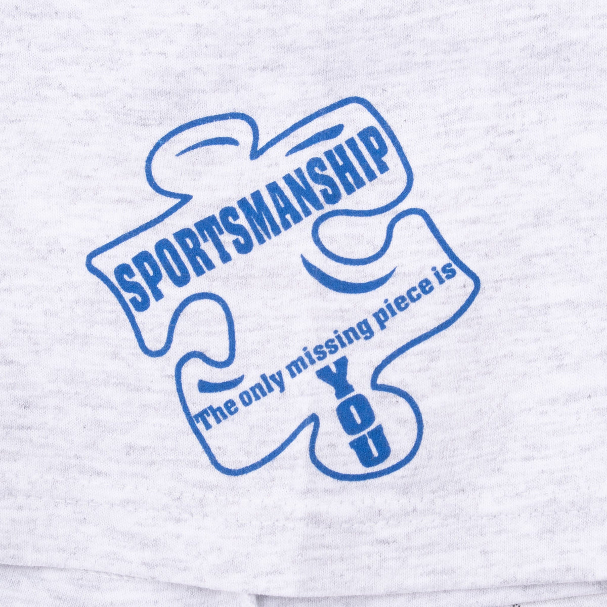 Close-up of blue Sportsmanship puzzle-piece sleeve print