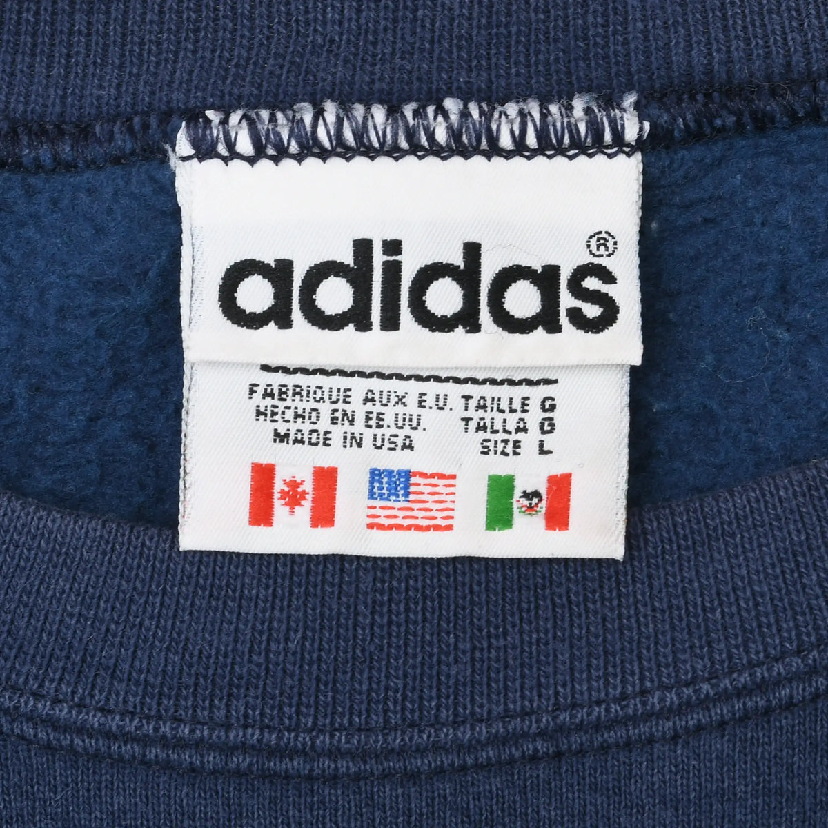 Close-up of adidas neck label marked size large and made in USA