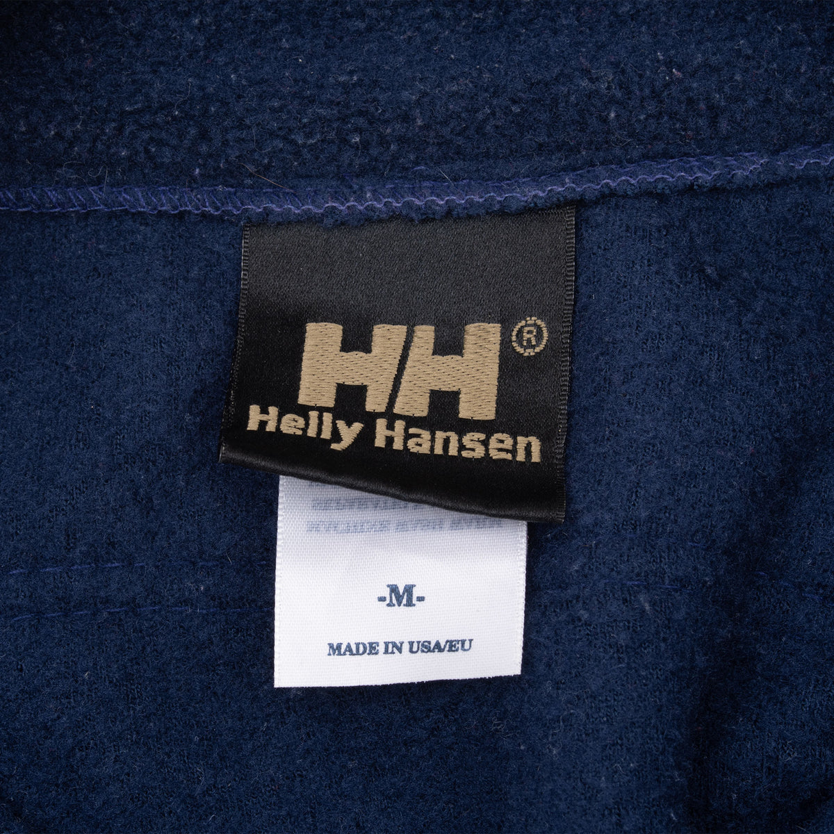 Helly Hansen neck label with medium size and Made in USA/EU text