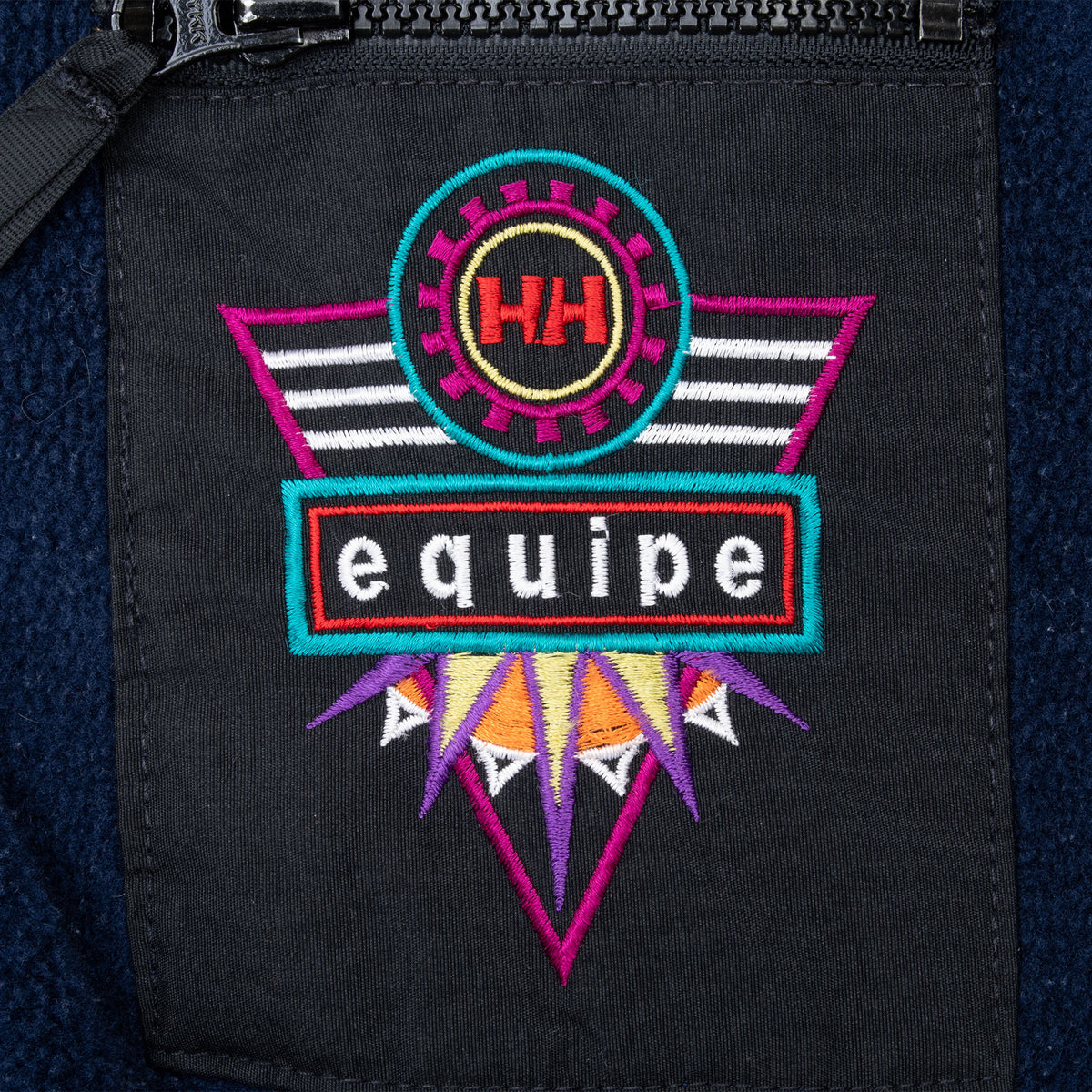 Colorful Helly Hansen Equipe embroidered graphic on black chest pocket