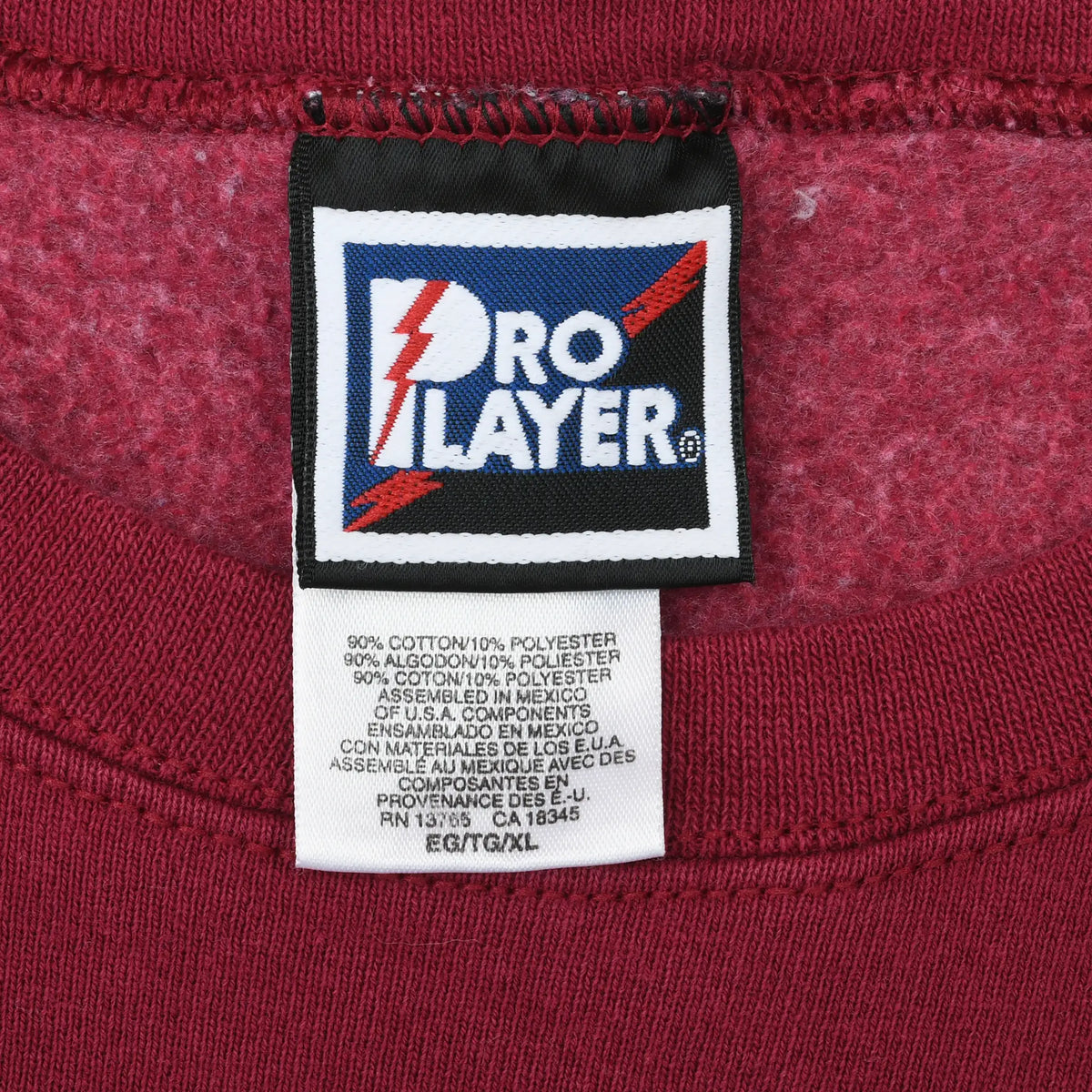 Close-up of Pro Player neck tag and care label inside burgundy sweatshirt