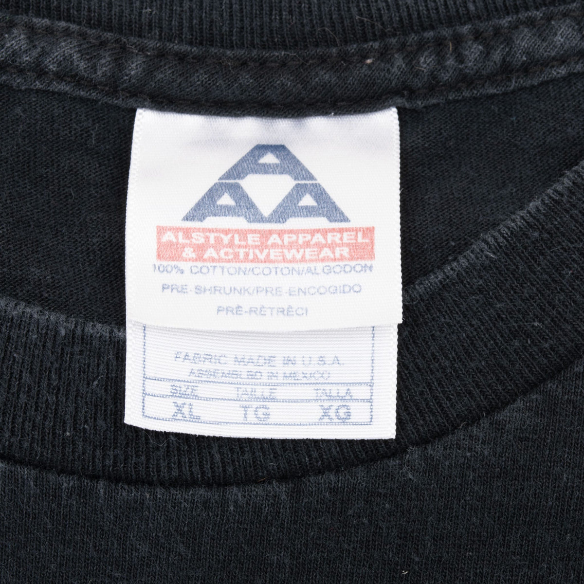 Close-up of Alstyle Apparel neck label marked XL on black T-shirt