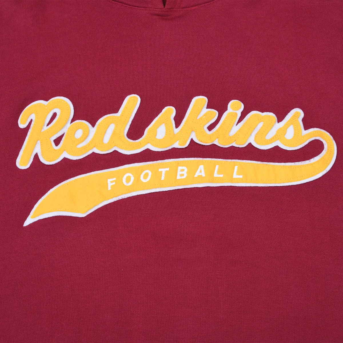 Close-up of gold and white Redskins Football script on the burgundy hoodie chest