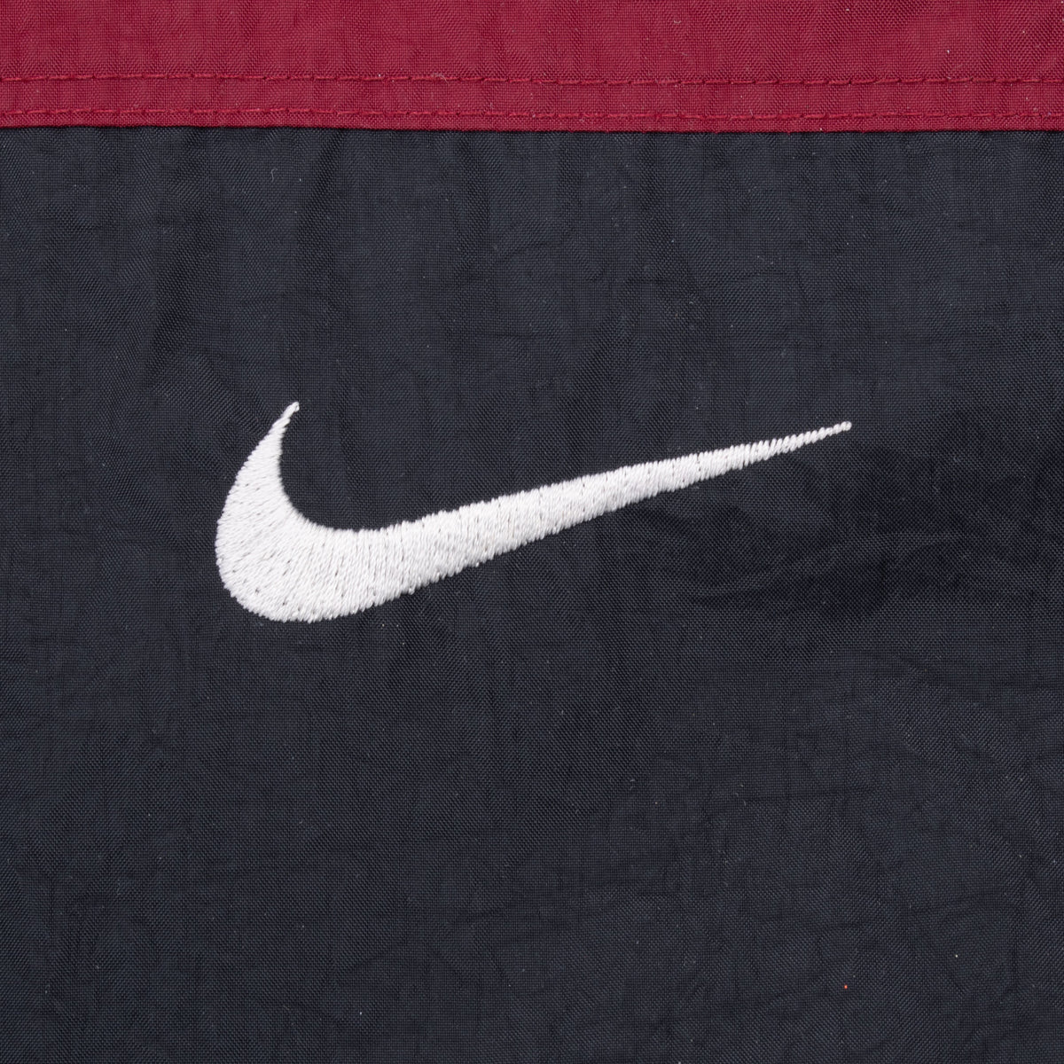 White embroidered Nike Swoosh on black front panel