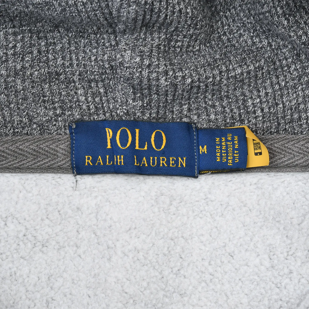 Polo Ralph Lauren neck label with medium size tag inside grey hoodie