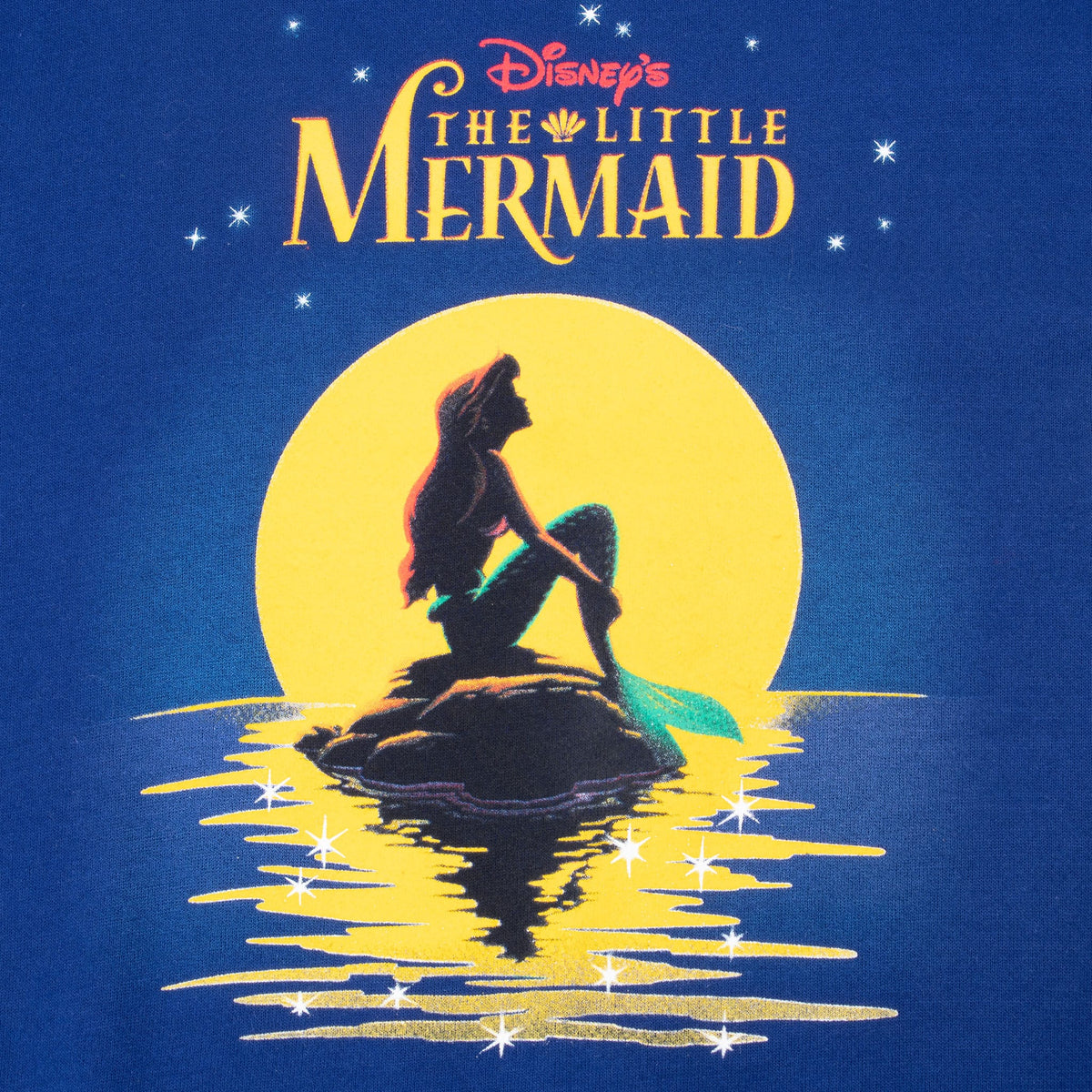 The Little Mermaid front graphic with Ariel silhouetted against a yellow moon