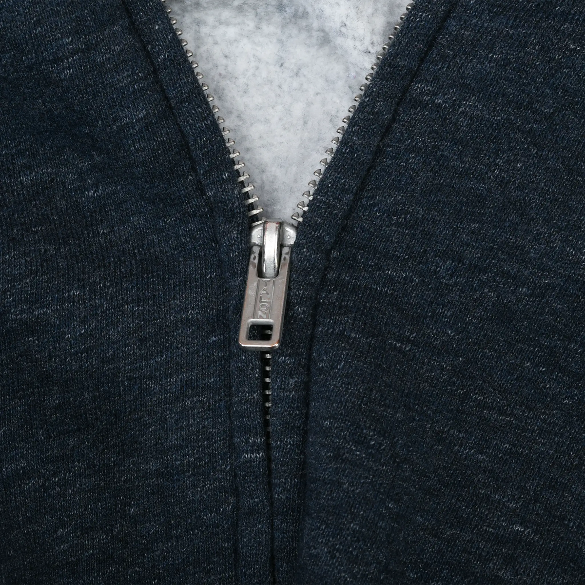 Close-up of metal zipper and light gray interior on blue Ralph Lauren hoodie