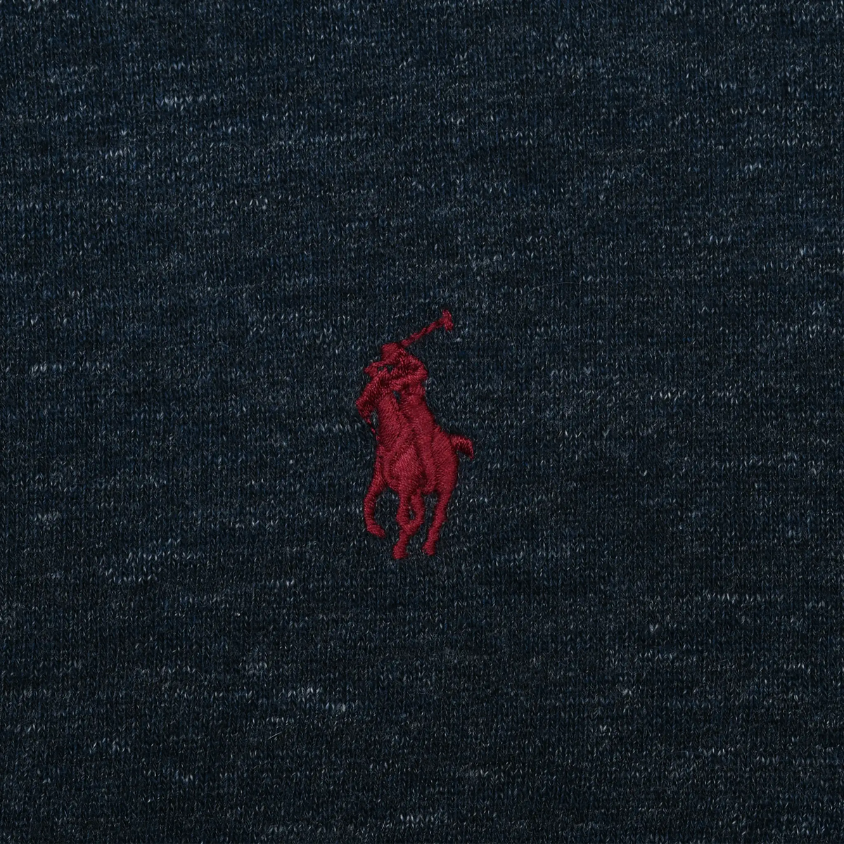 Close-up of red Polo pony embroidery on blue hoodie chest