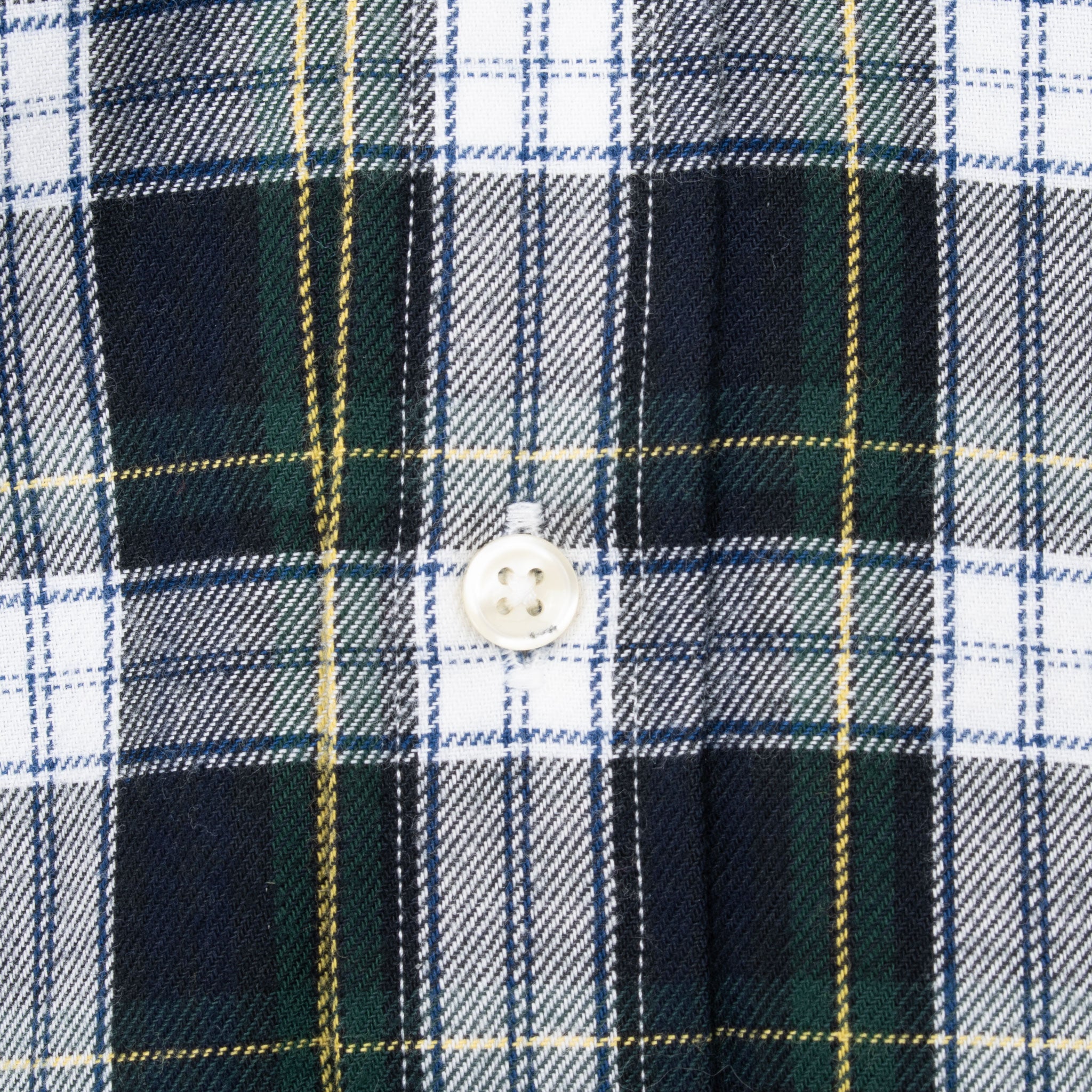 Close-up of white button and stitching on Ralph Lauren tartan plaid shirt