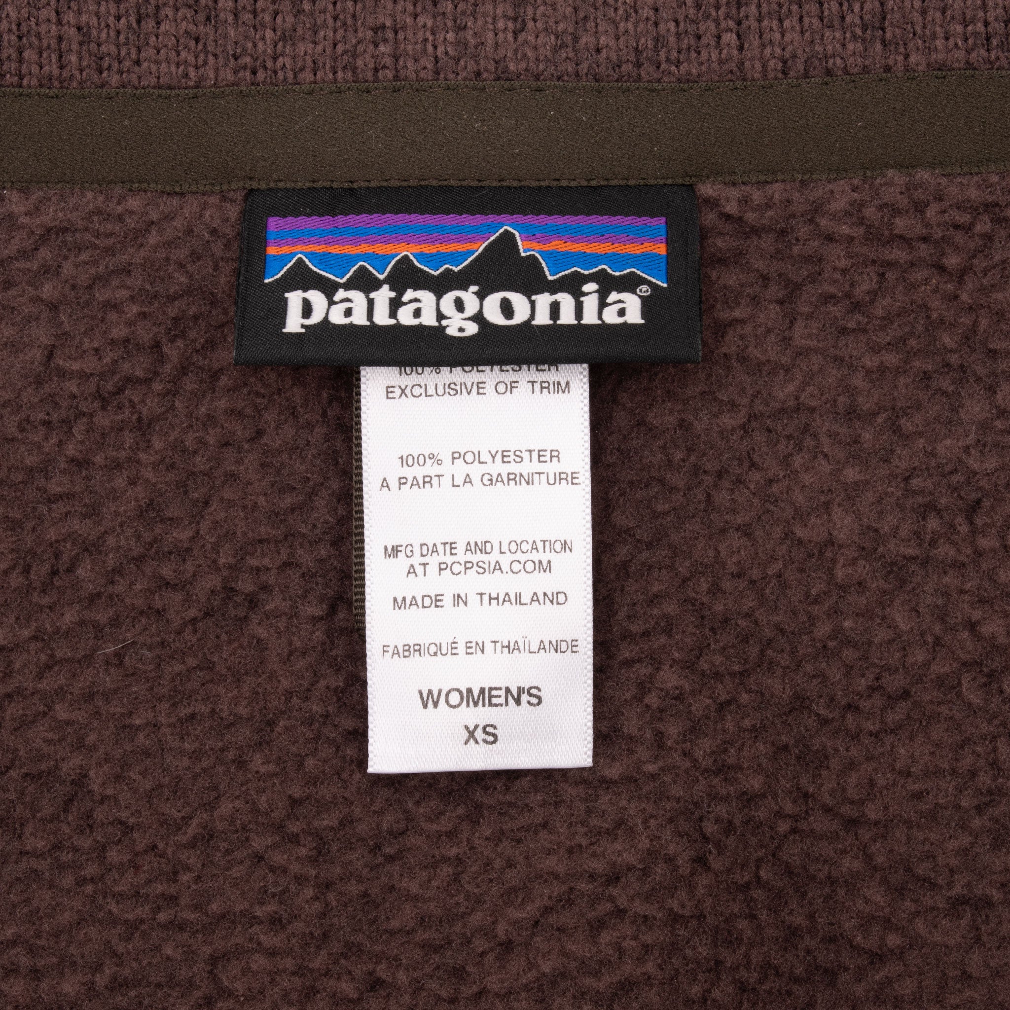 Patagonia neck label and women's XS size tag inside brown fleece coat