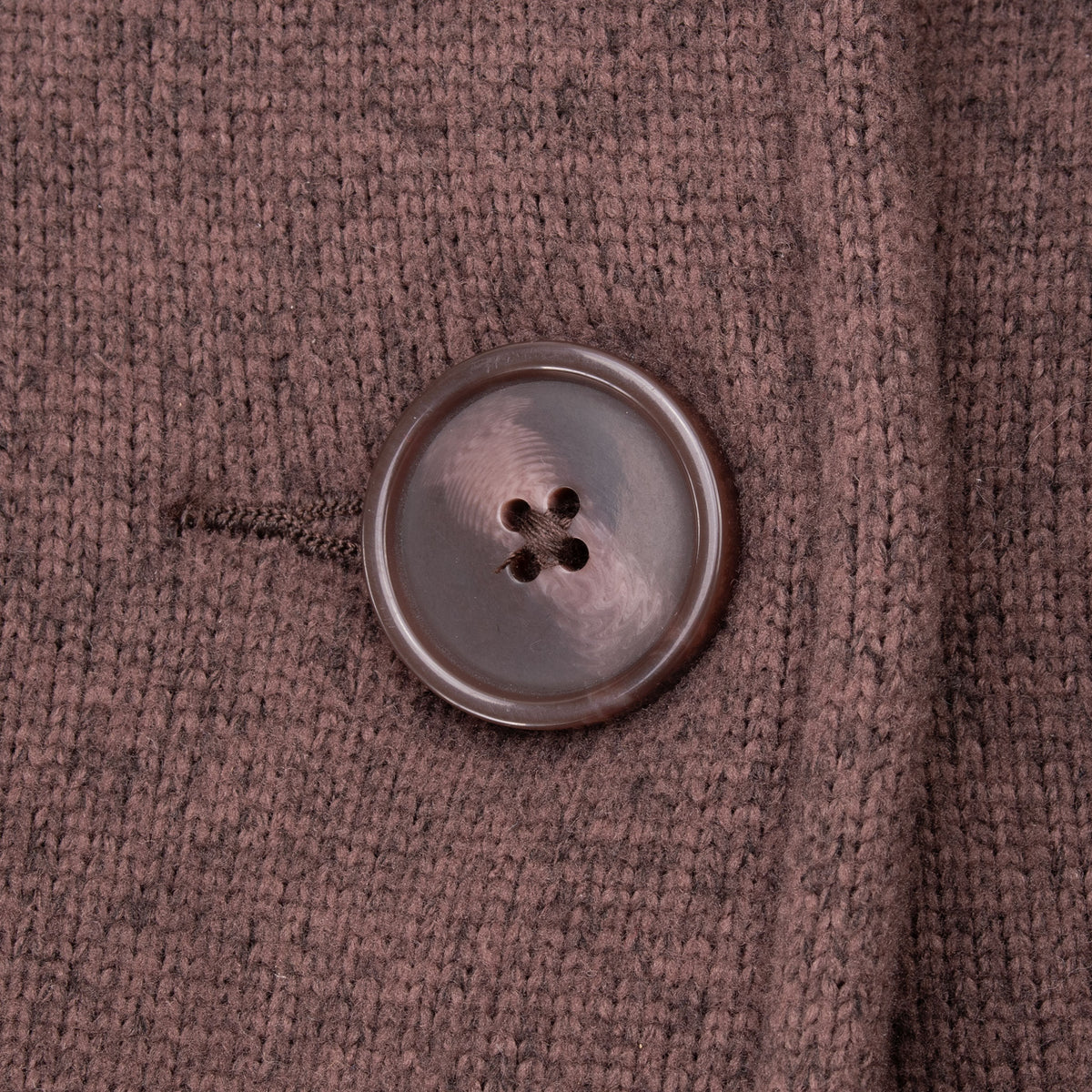 Close-up of brown four-hole button and fleece texture on Patagonia coat