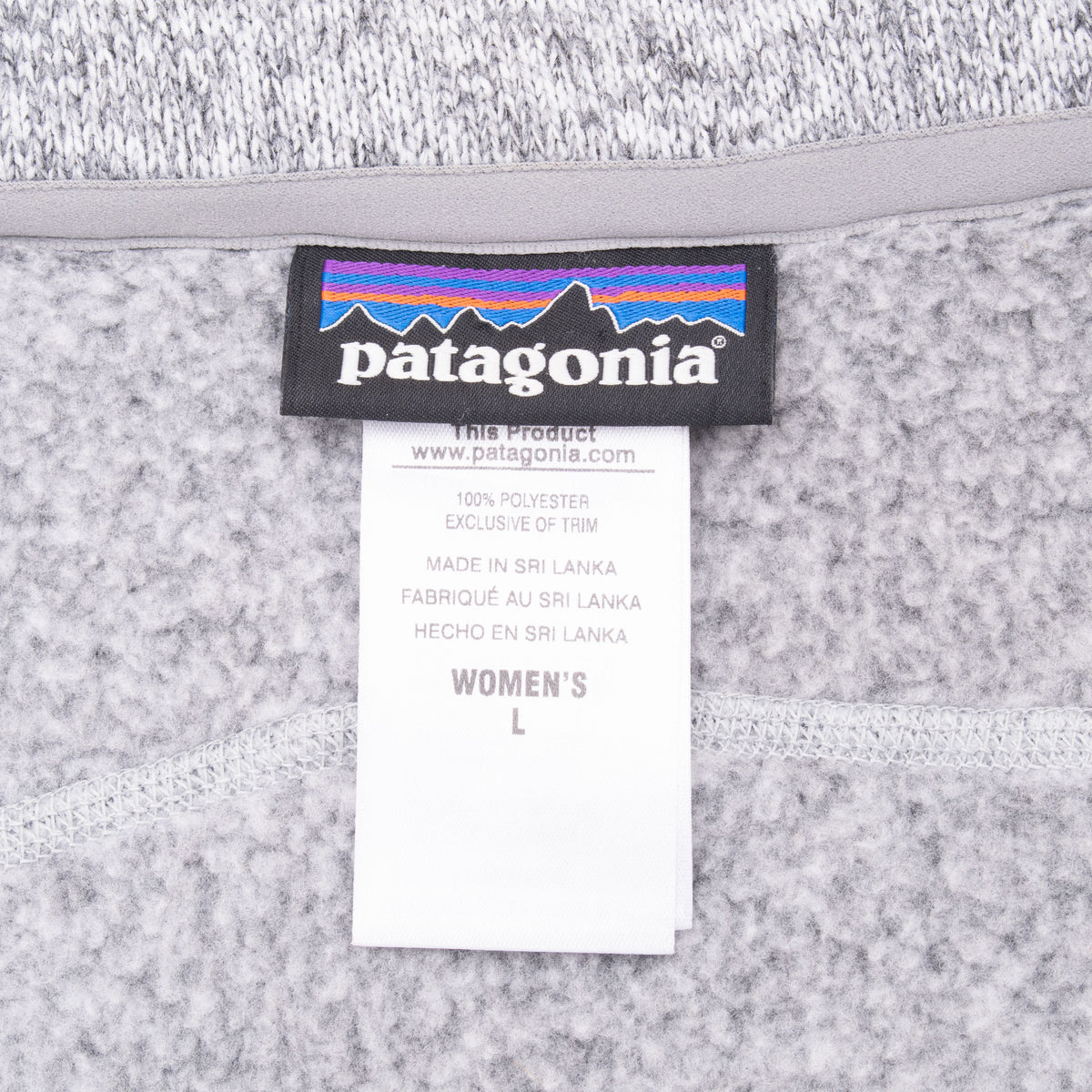 Patagonia neck label and women's large size tag inside grey fleece vest