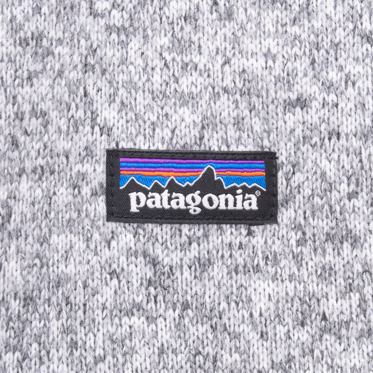 Close-up of Patagonia logo patch on grey knit fleece