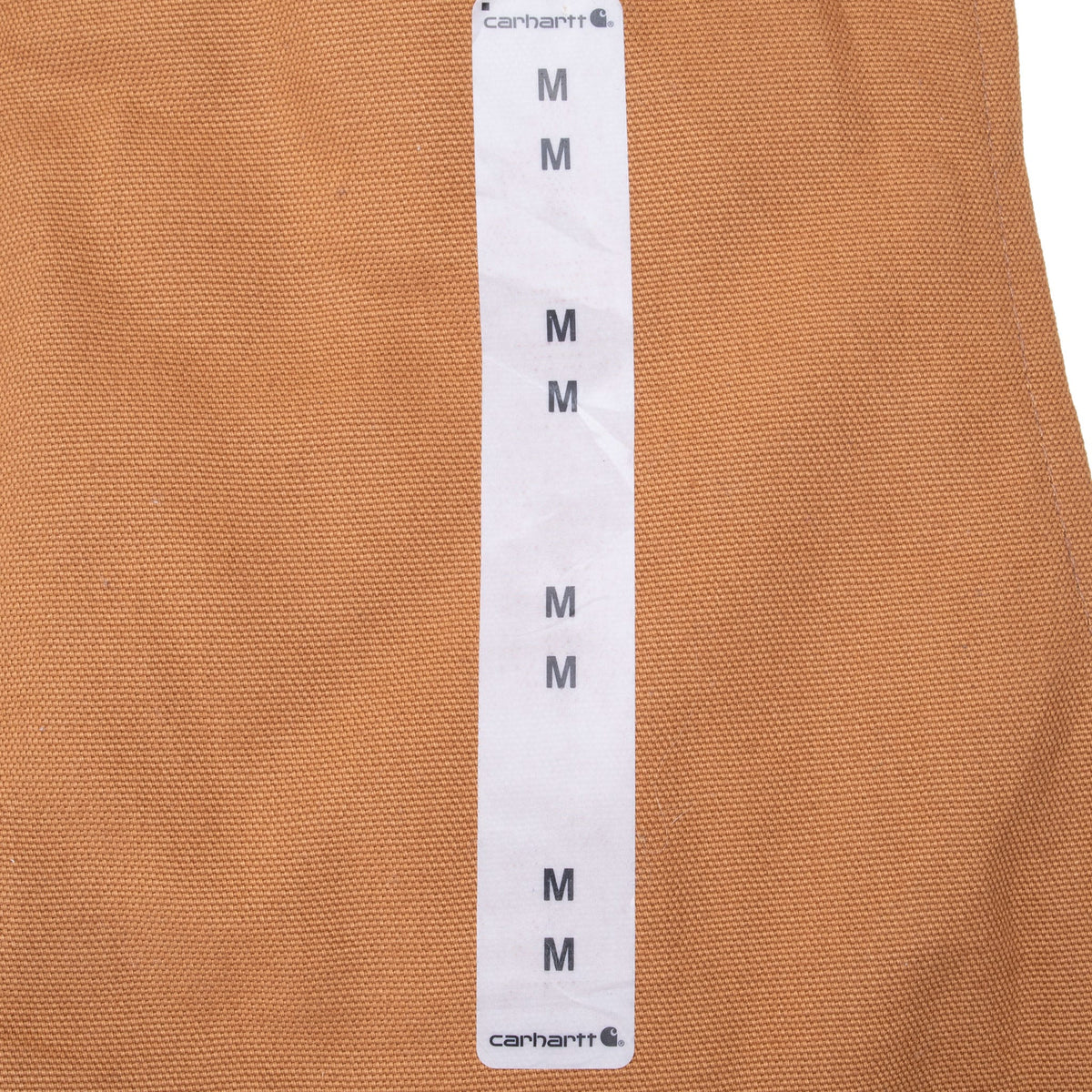 Original Carhartt Medium size strip attached to brown vest front