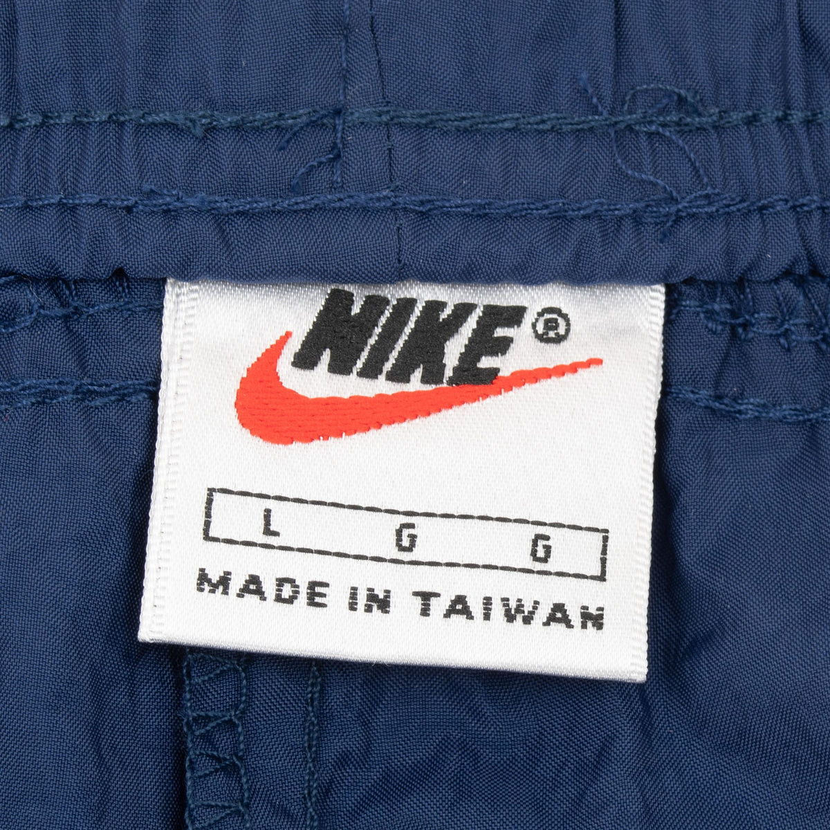 Nike size Large garment label inside blue track pants