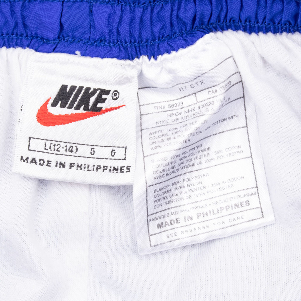 Nike brand and care labels inside blue-purple women's track pants