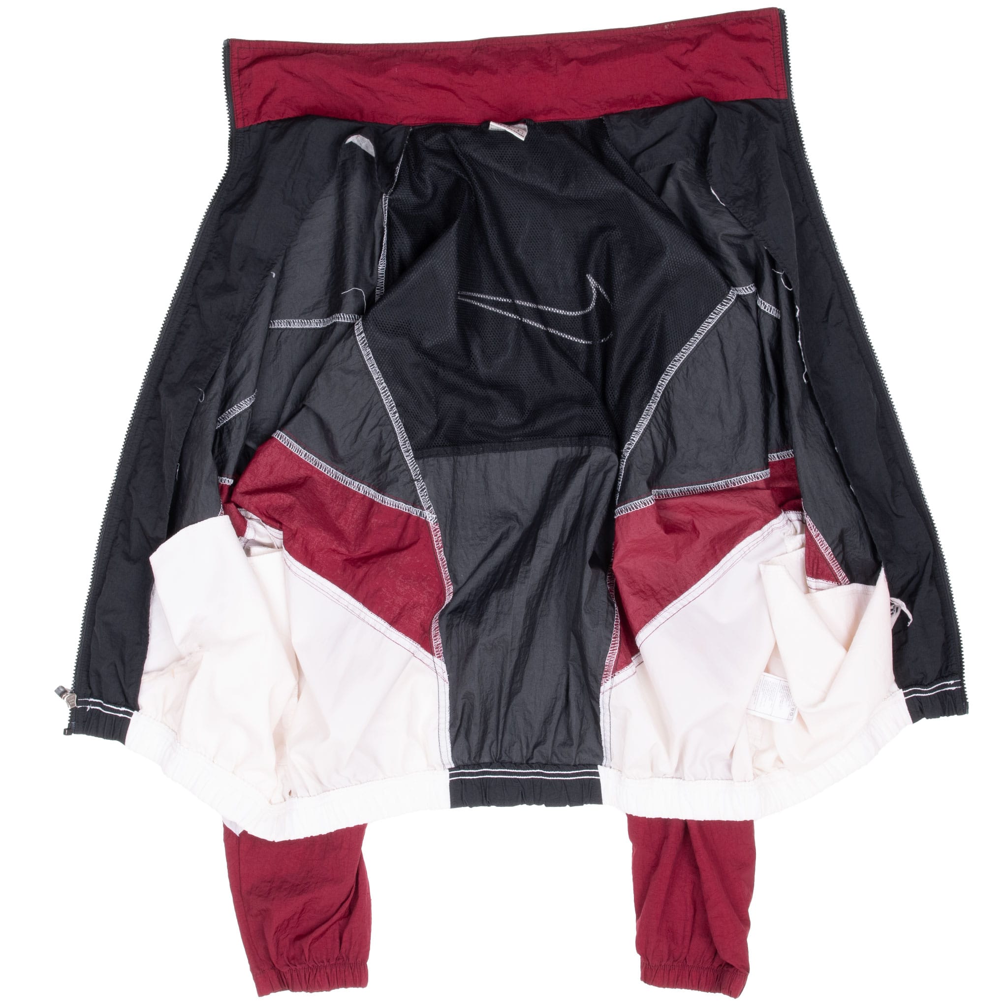 Interior view of unzipped Nike windbreaker showing black mesh lining and color-blocked panels