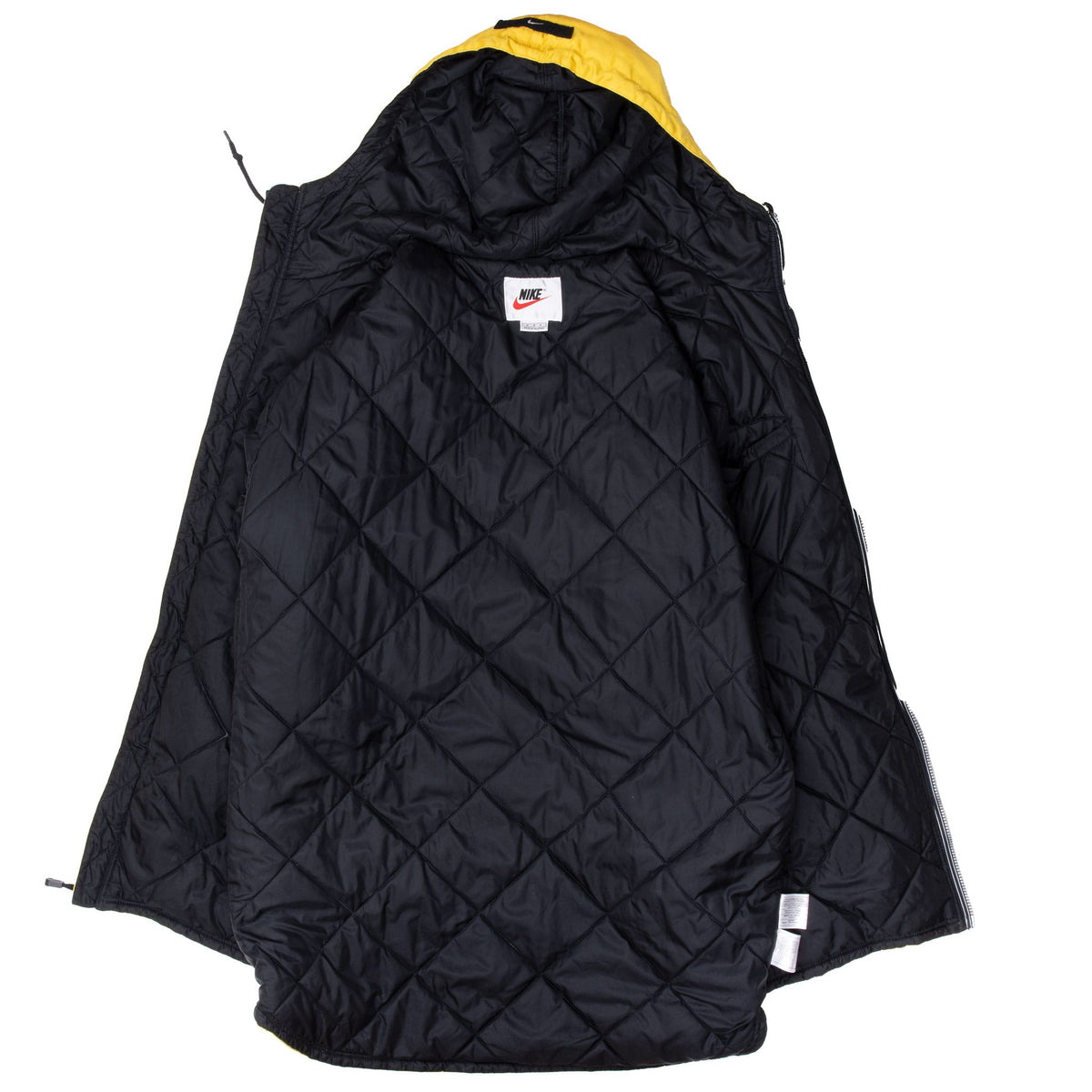 Interior of Nike rain jacket showing black diamond-quilted lining, hood and neck label