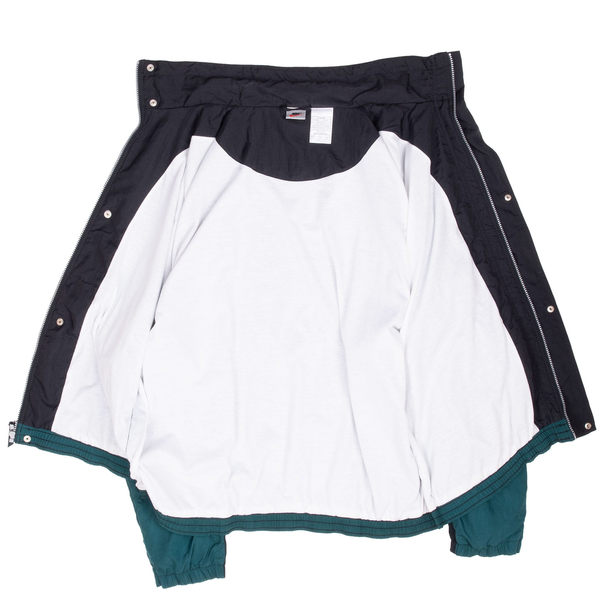 Open Nike windbreaker showing white body lining, black upper lining and interior labels