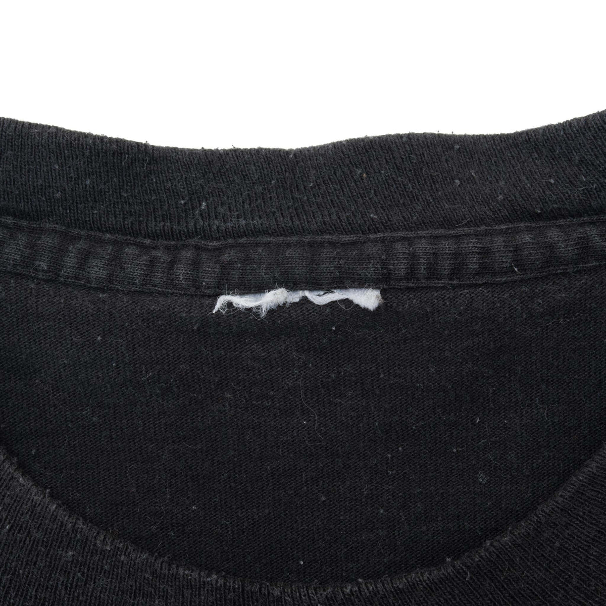 Interior collar detail of black Harley-Davidson T-shirt with partially removed neck label