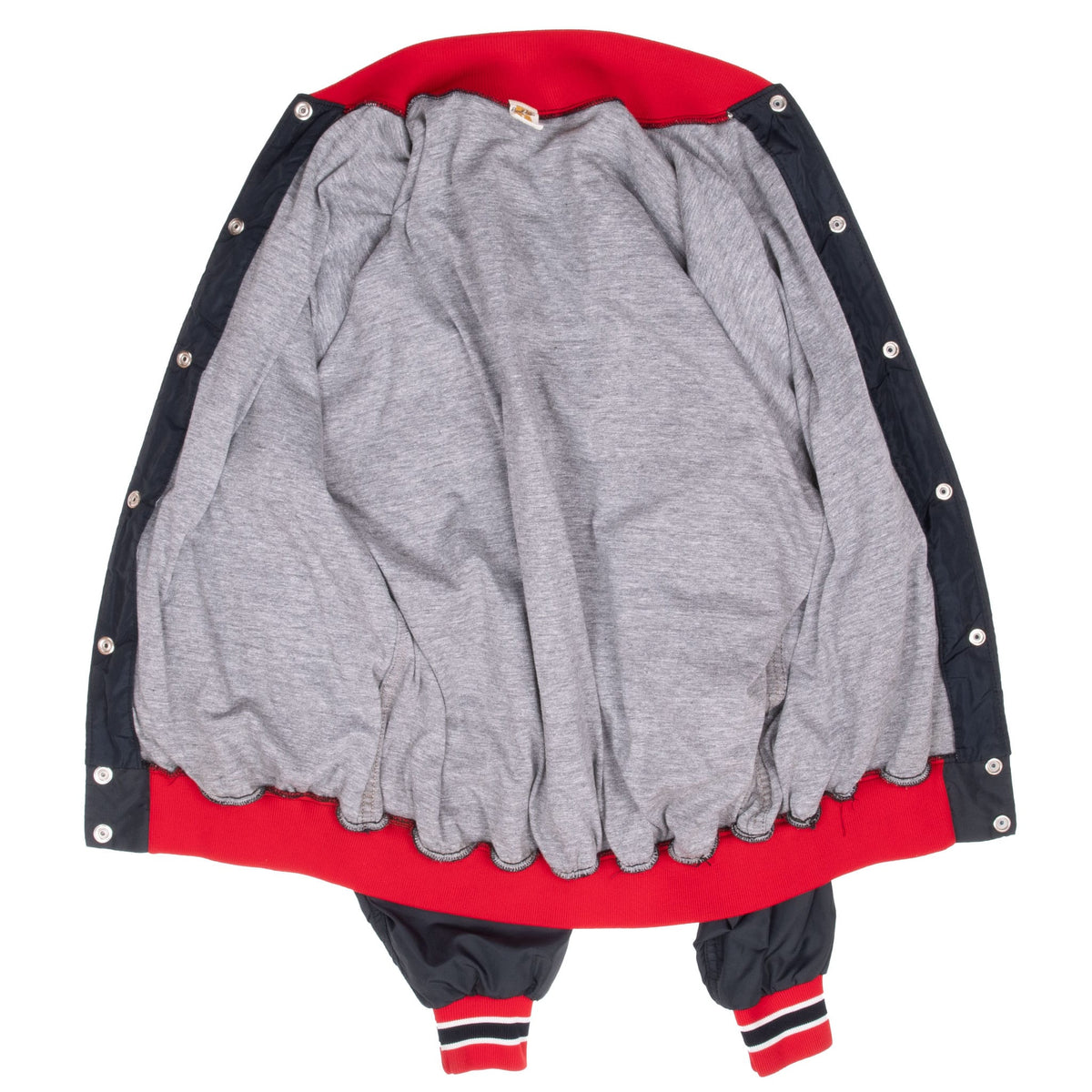 Open black Texas Tech bomber jacket showing gray interior lining and snap closure