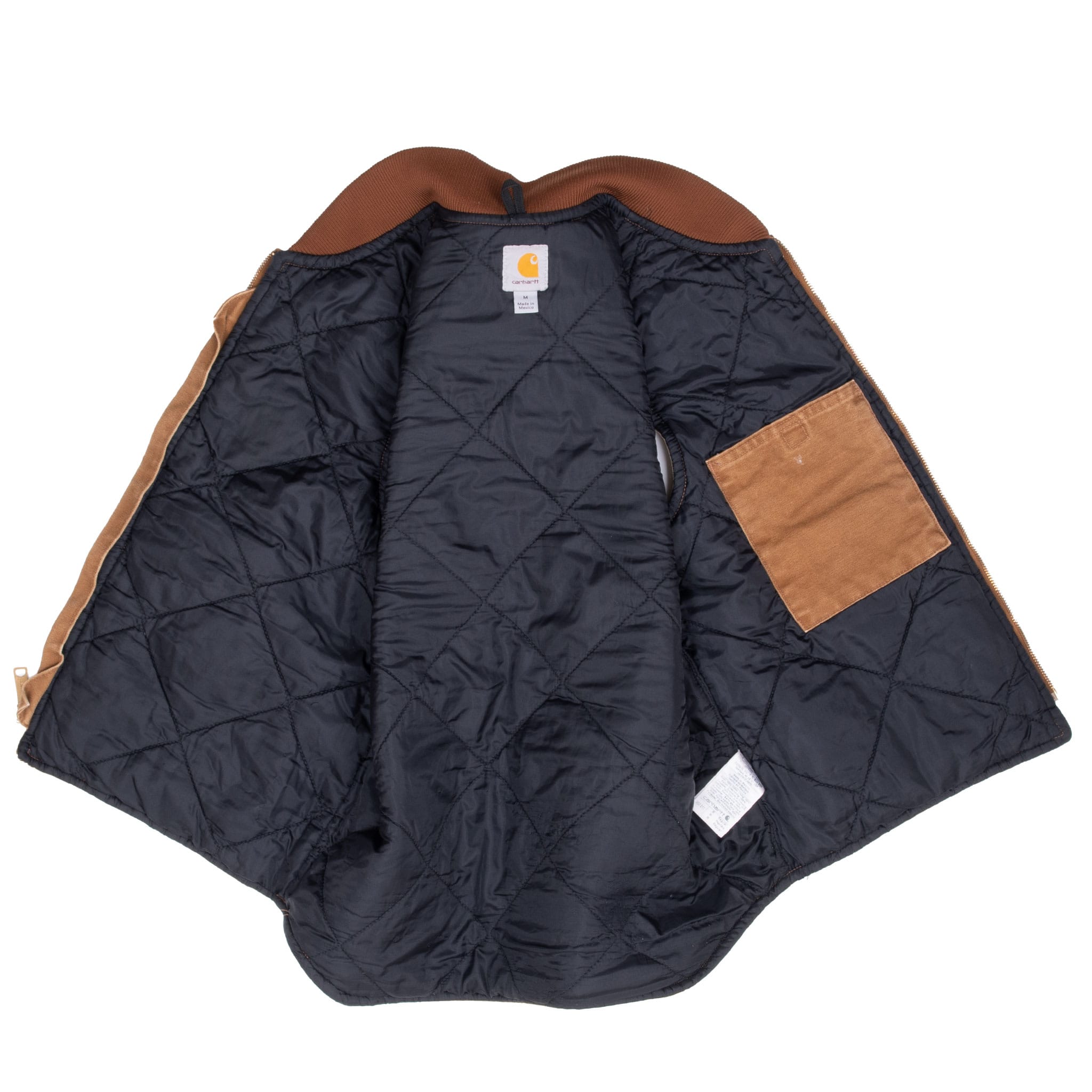 Open Carhartt vest showing dark diamond-quilted lining and interior patch pocket