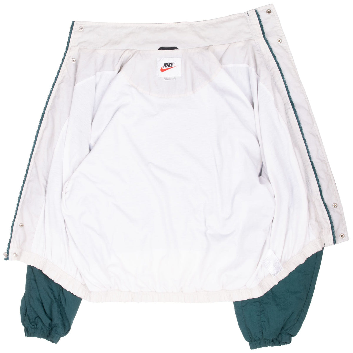 Interior of Nike windbreaker showing white lining, neck label and open snap placket