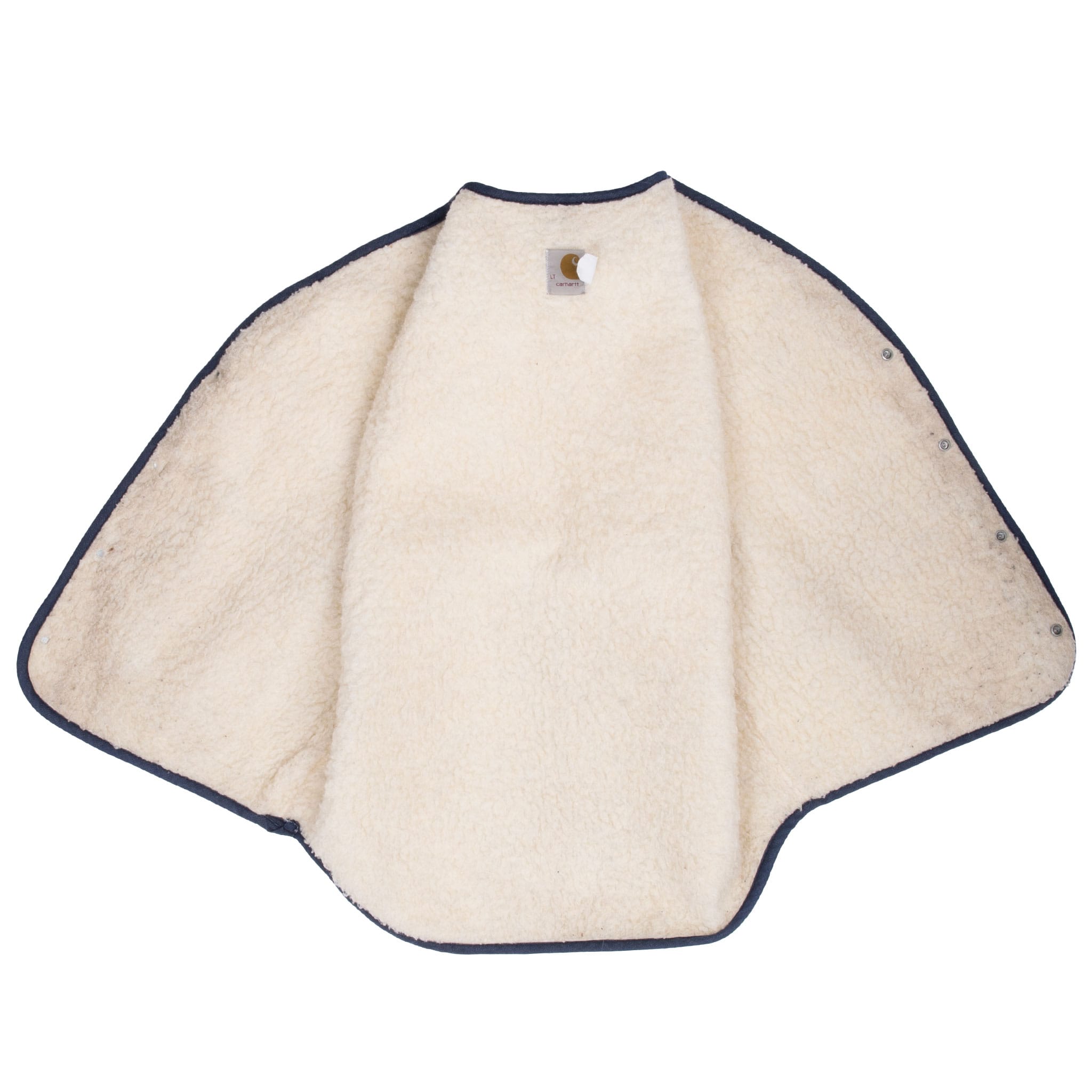 Open interior of Carhartt denim vest showing cream sherpa lining and bound edges