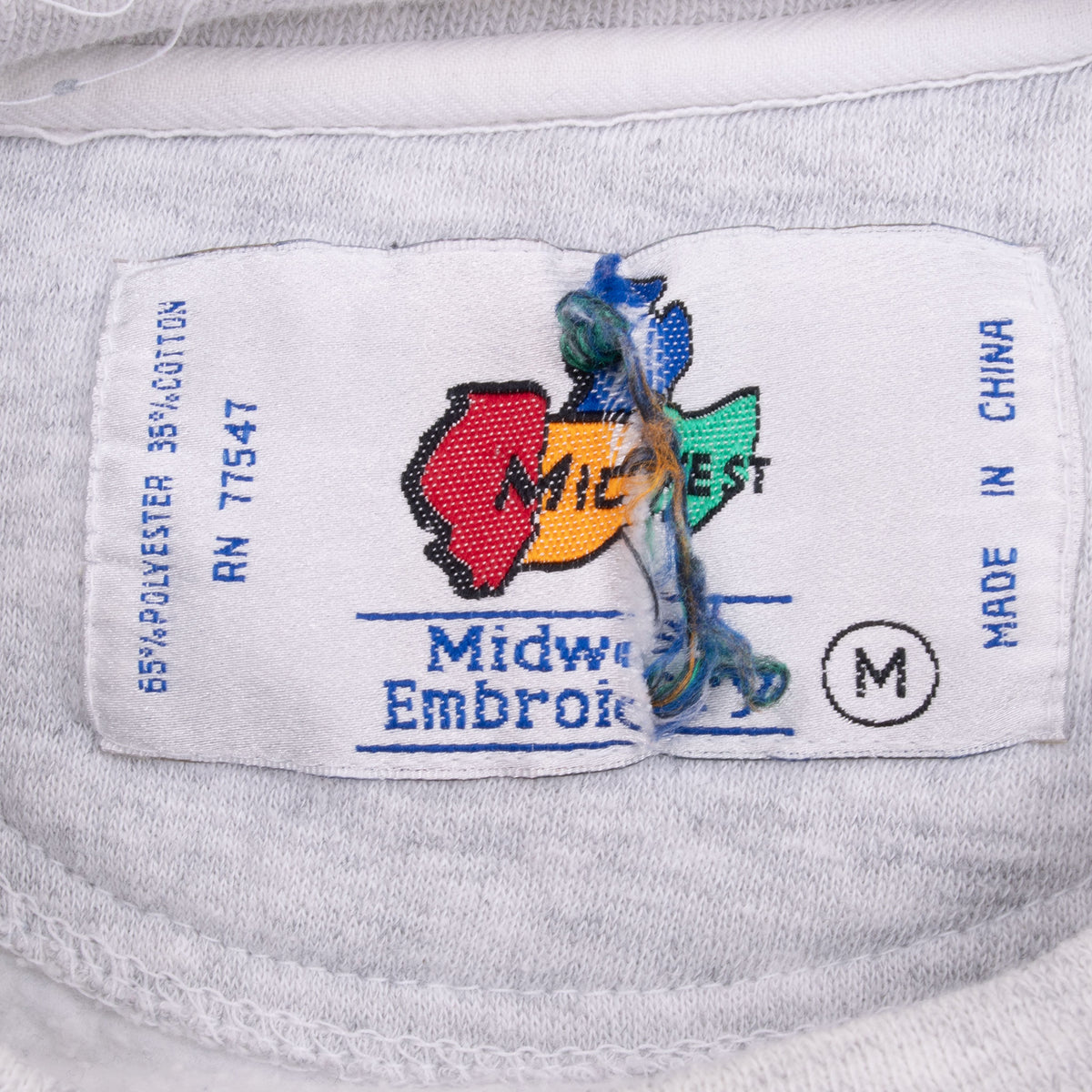 Midwest Embroidery medium neck label with loose multicolor threads