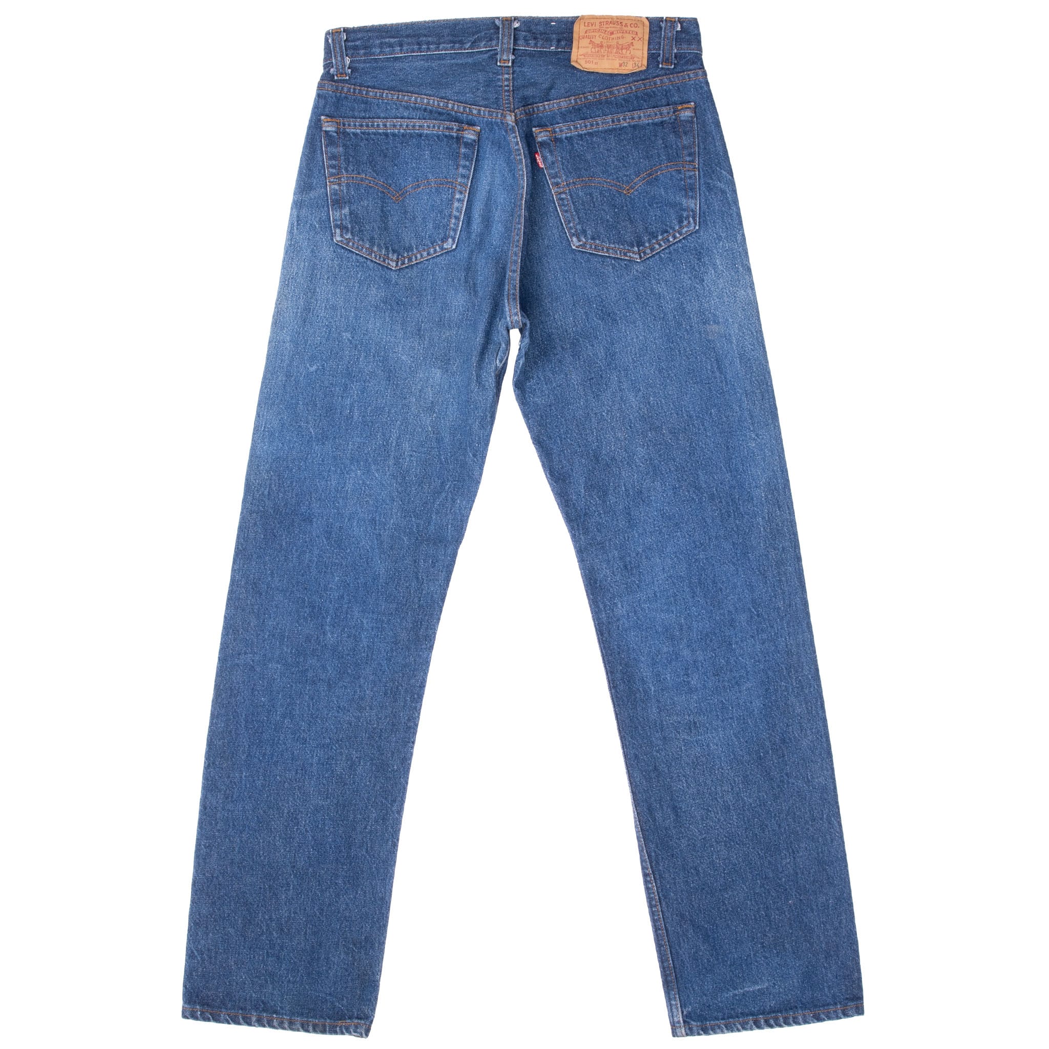Back of Levi's 501 indigo blue jeans with arcuate-stitched pockets, red tab and waist patch
