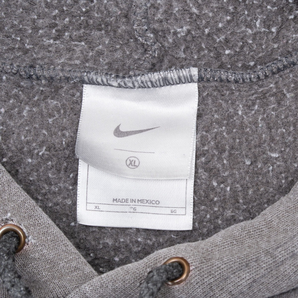 Nike neck tag inside faded grey hoodie, marked XL and made in Mexico