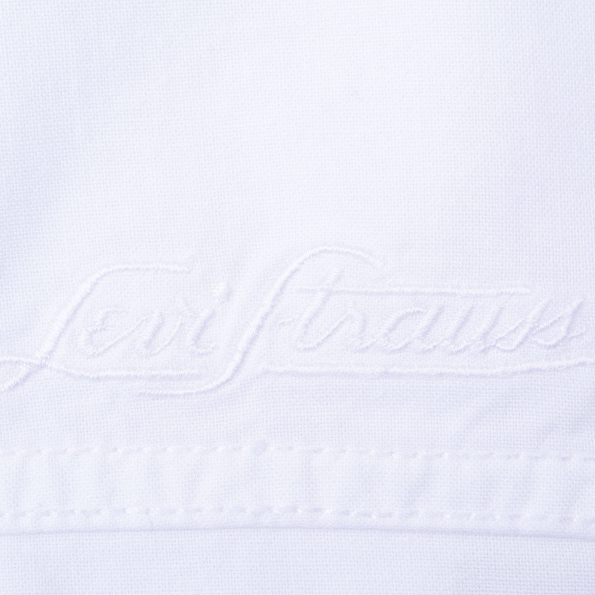 Tonal white Levi Strauss script embroidery above chest seam