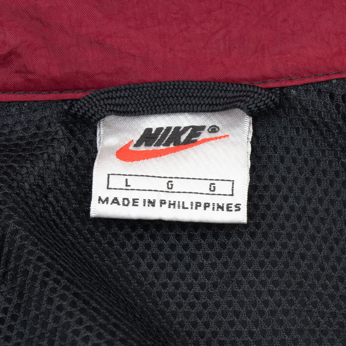 Nike neck label marked size L and Made in Philippines inside black mesh lining