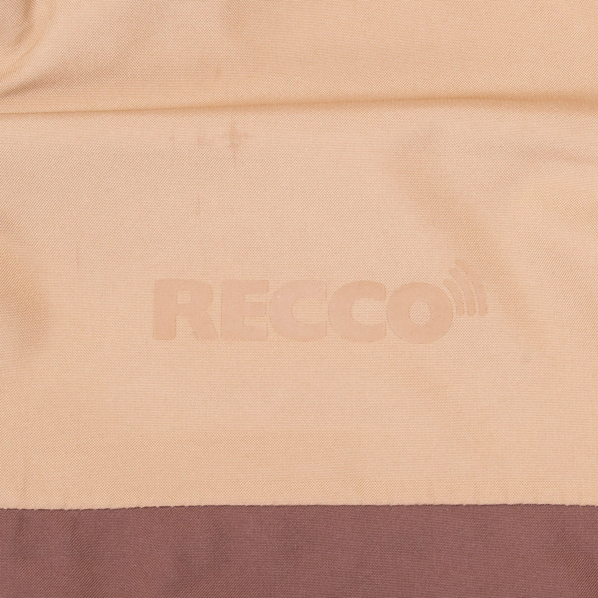 Tonal RECCO lettering detail on the tan upper back panel