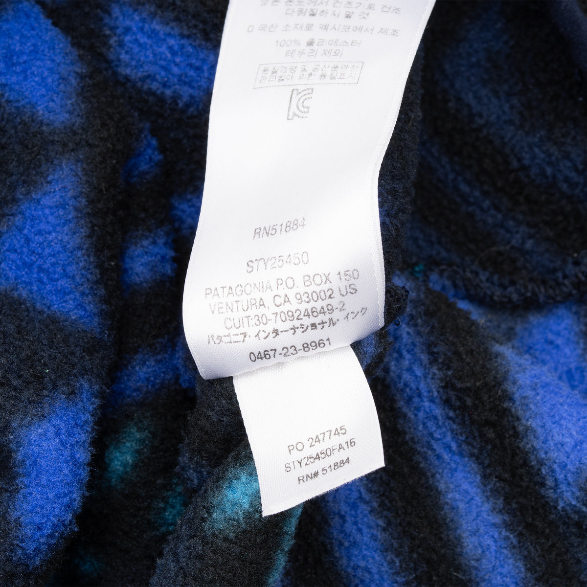 Close-up of interior care and style tags on Patagonia patterned fleece