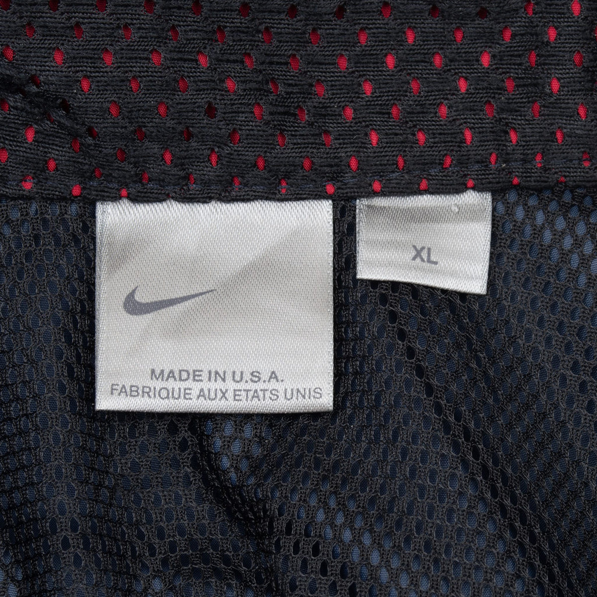 Nike jacket label showing size XL and Made in USA inside the mesh-lined collar