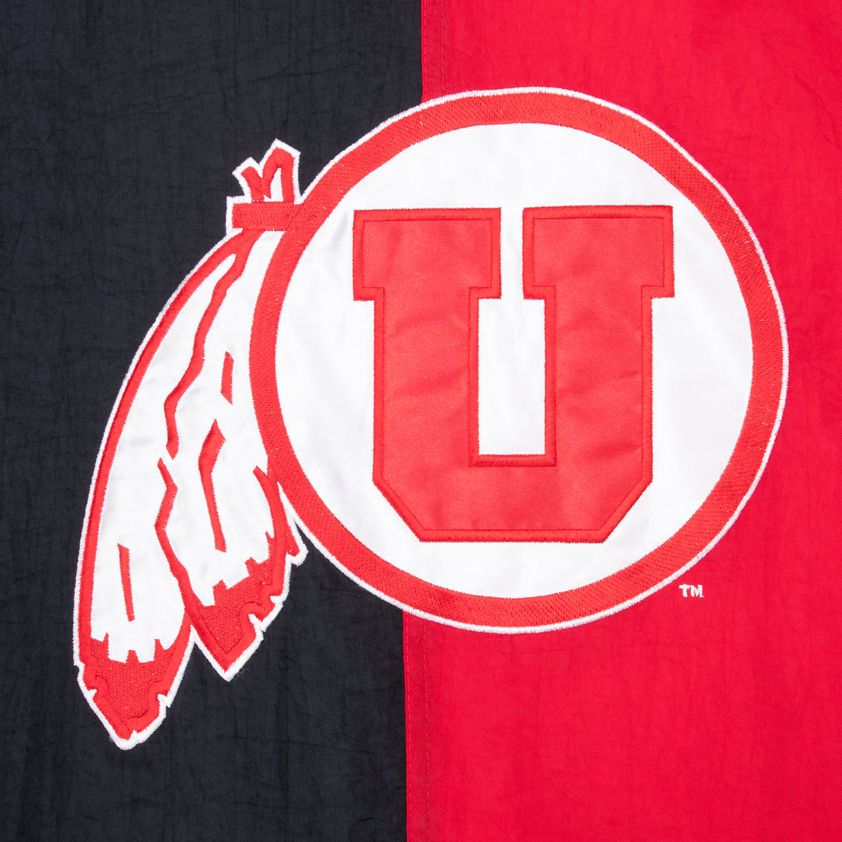 Close-up of large University of Utah U logo on red and black jacket back