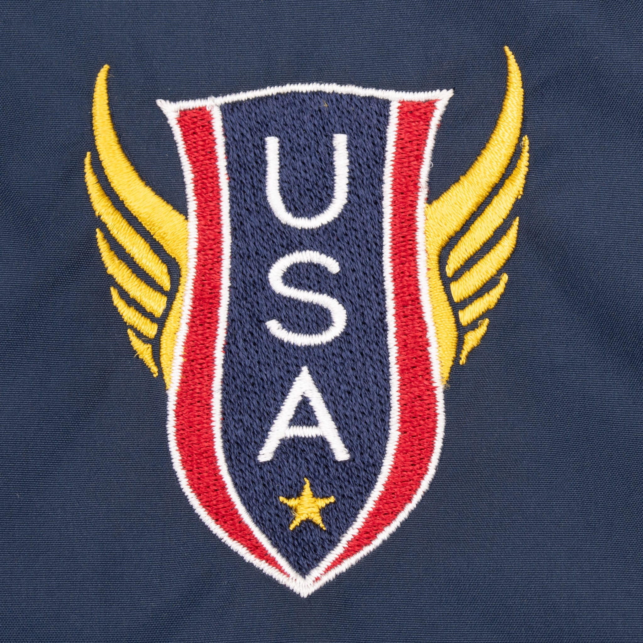 Close-up of embroidered red, white, blue and gold Team USA crest