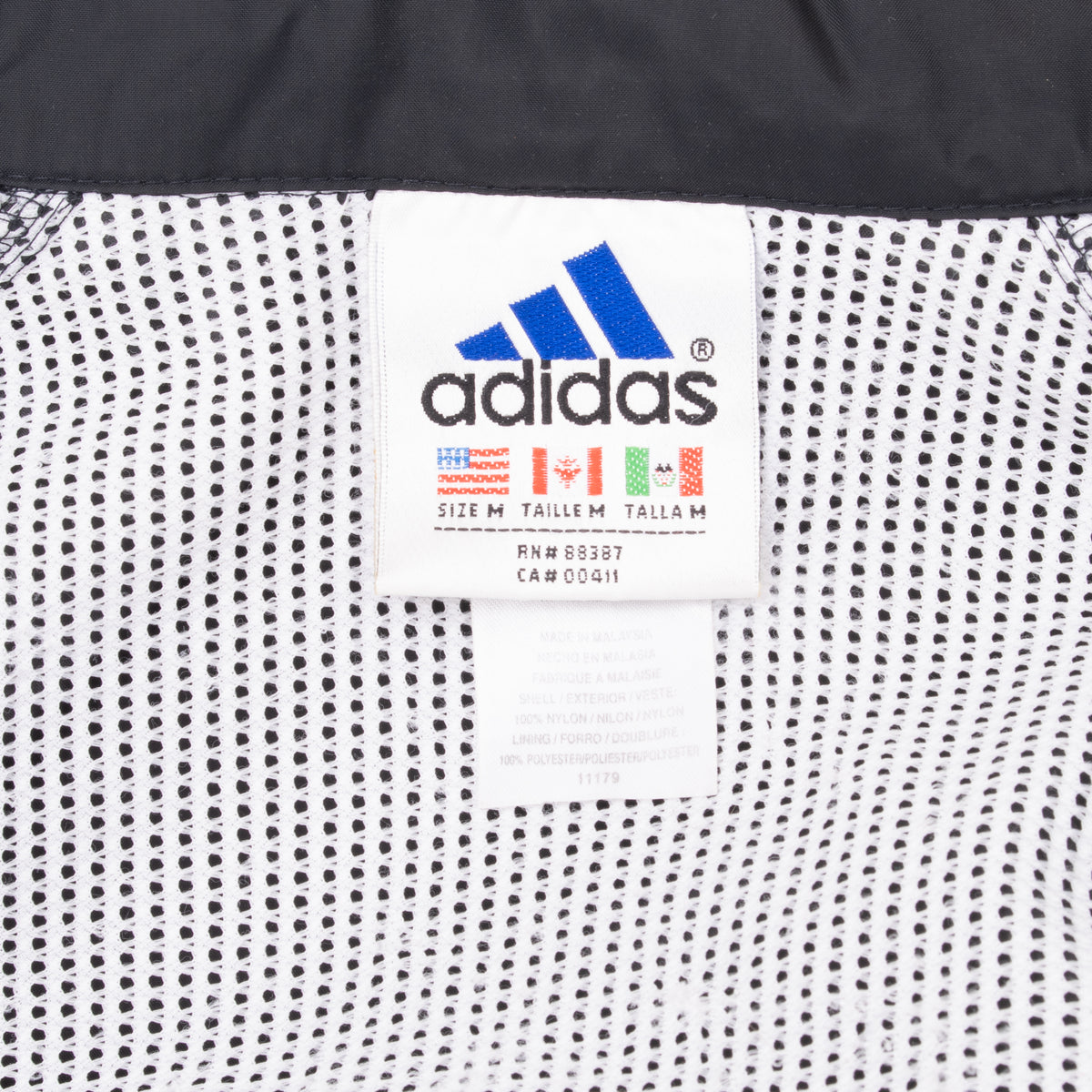 Adidas size medium label inside white mesh jacket lining