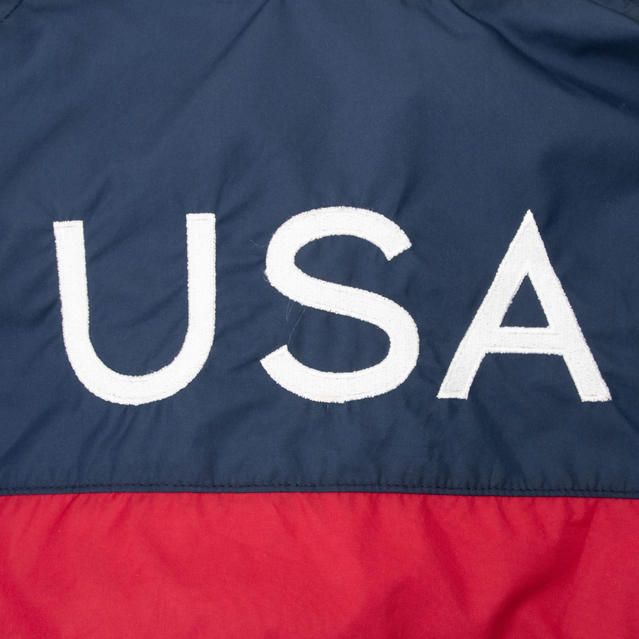 Close-up of white USA lettering above the red back panel
