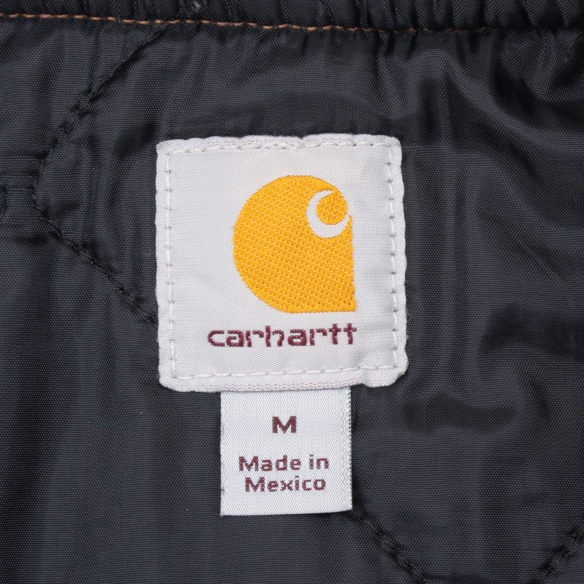 Carhartt interior neck label with size M and Made in Mexico text