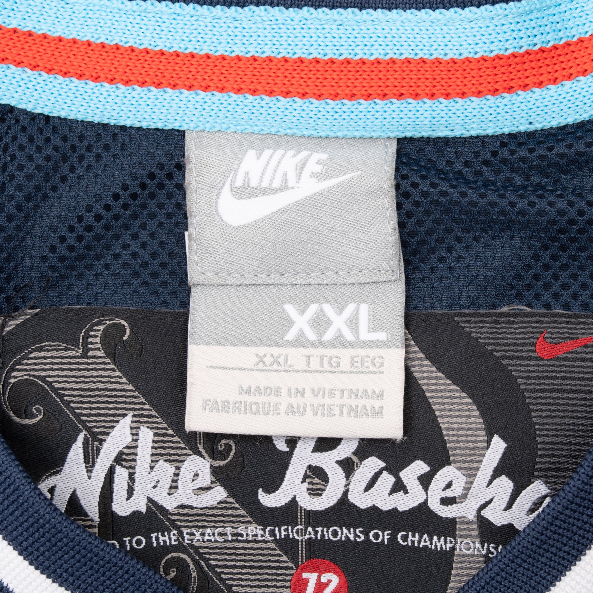 Nike XXL neck tag and Nike Baseball interior label beneath striped collar