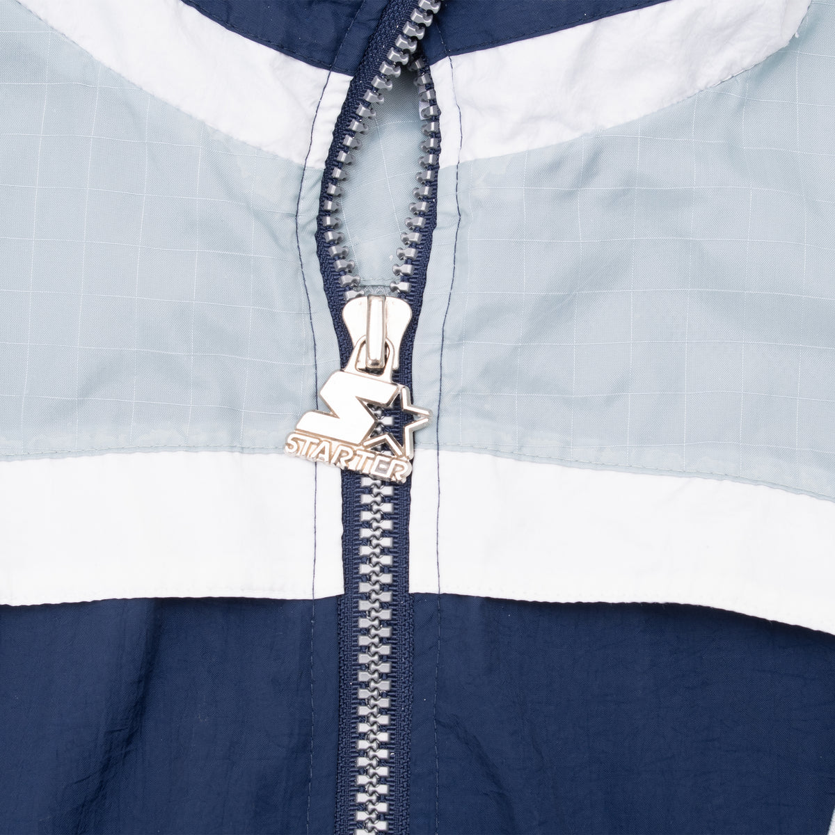 Close-up of Starter star zipper pull on Dallas Cowboys windbreaker
