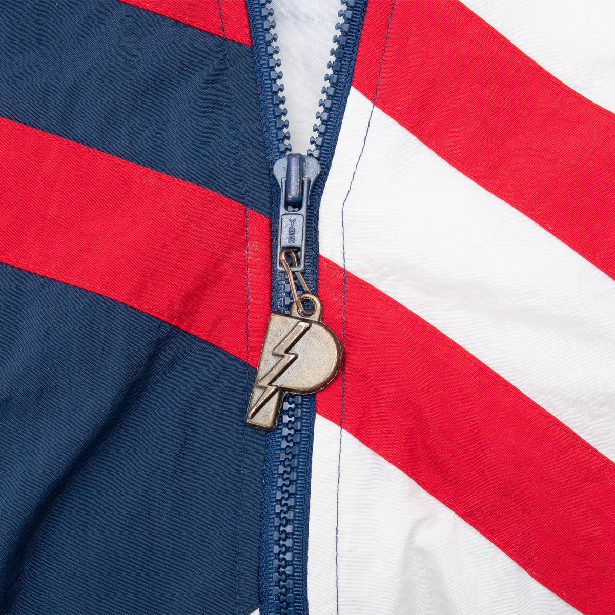 Close-up of zipper and lightning bolt pull on Team USA Basketball windbreaker