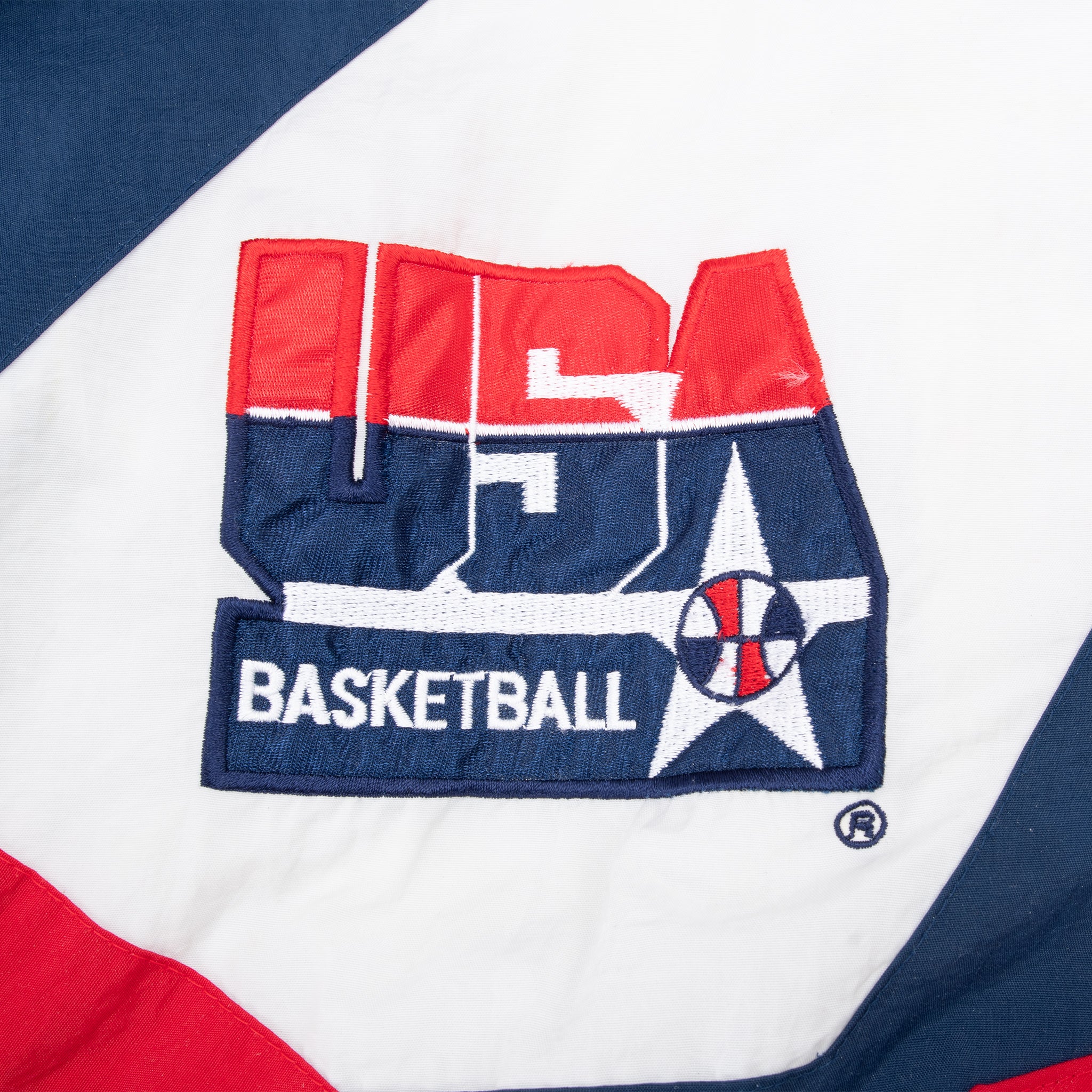 Embroidered USA Basketball chest logo on white windbreaker panel
