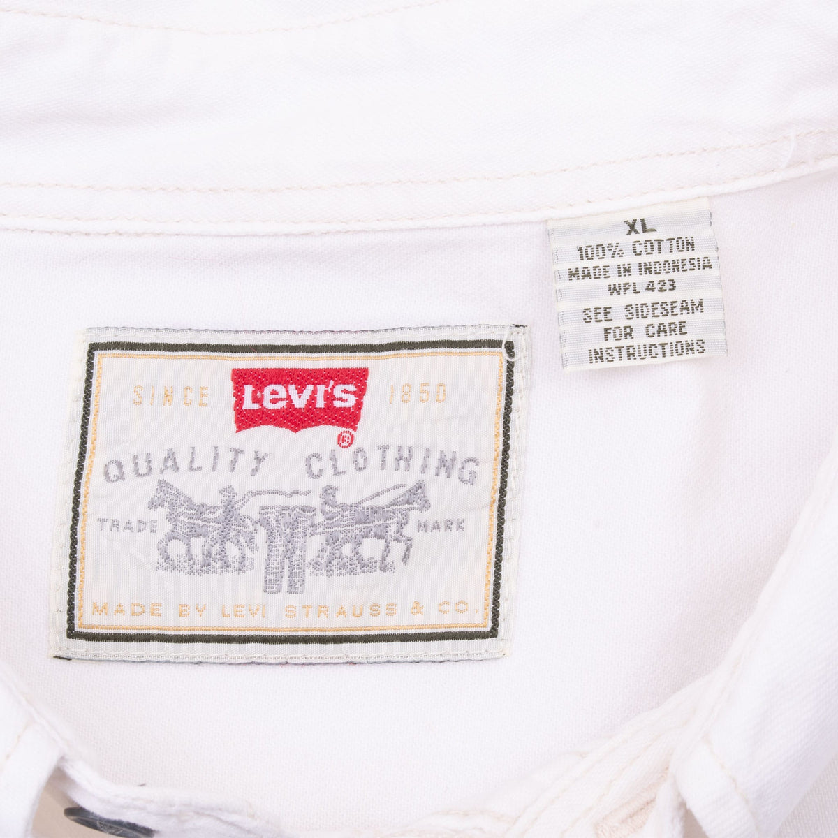 Levi's collar label and XL care tag inside white denim shirt