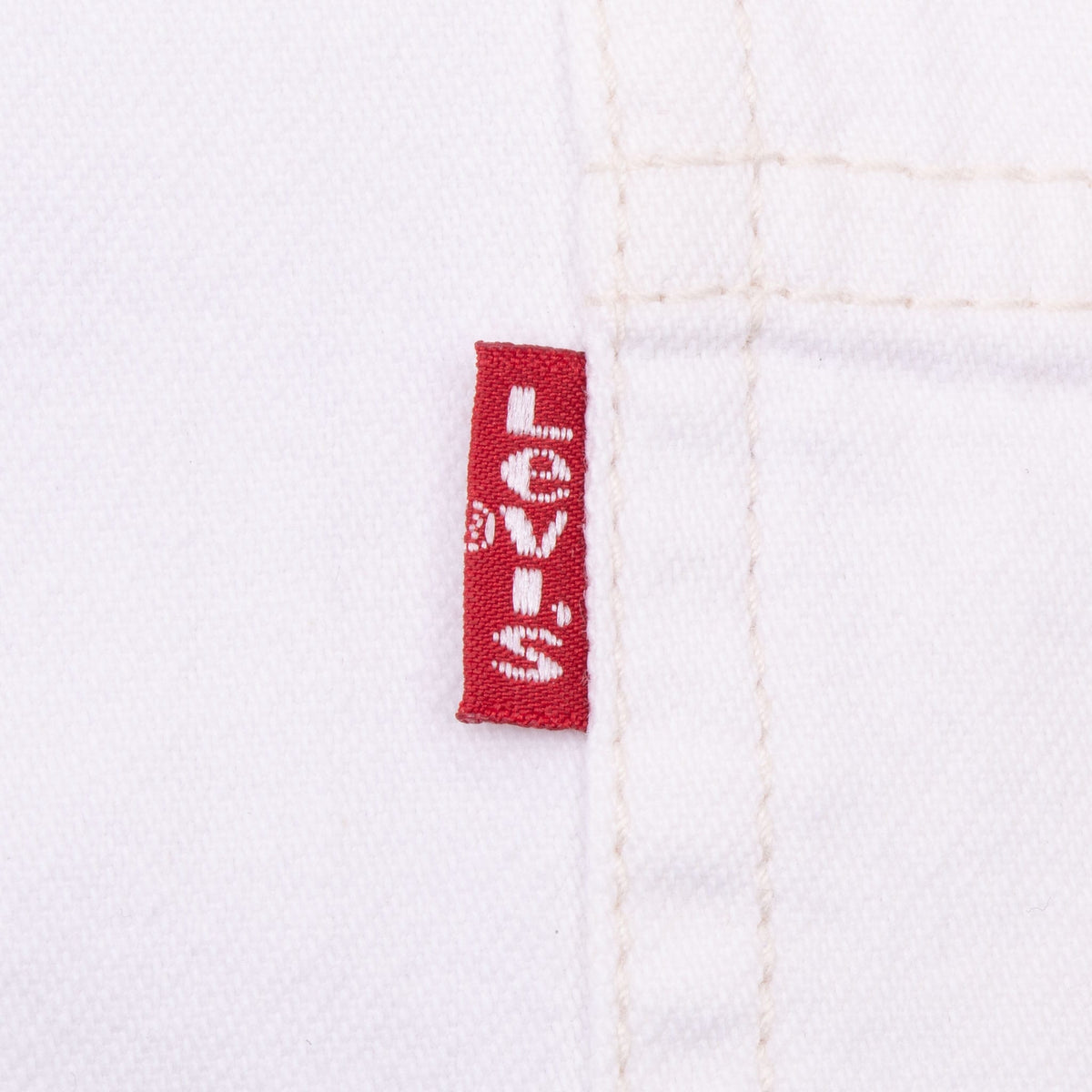 Close-up of red Levi's tab beside the white shirt chest pocket