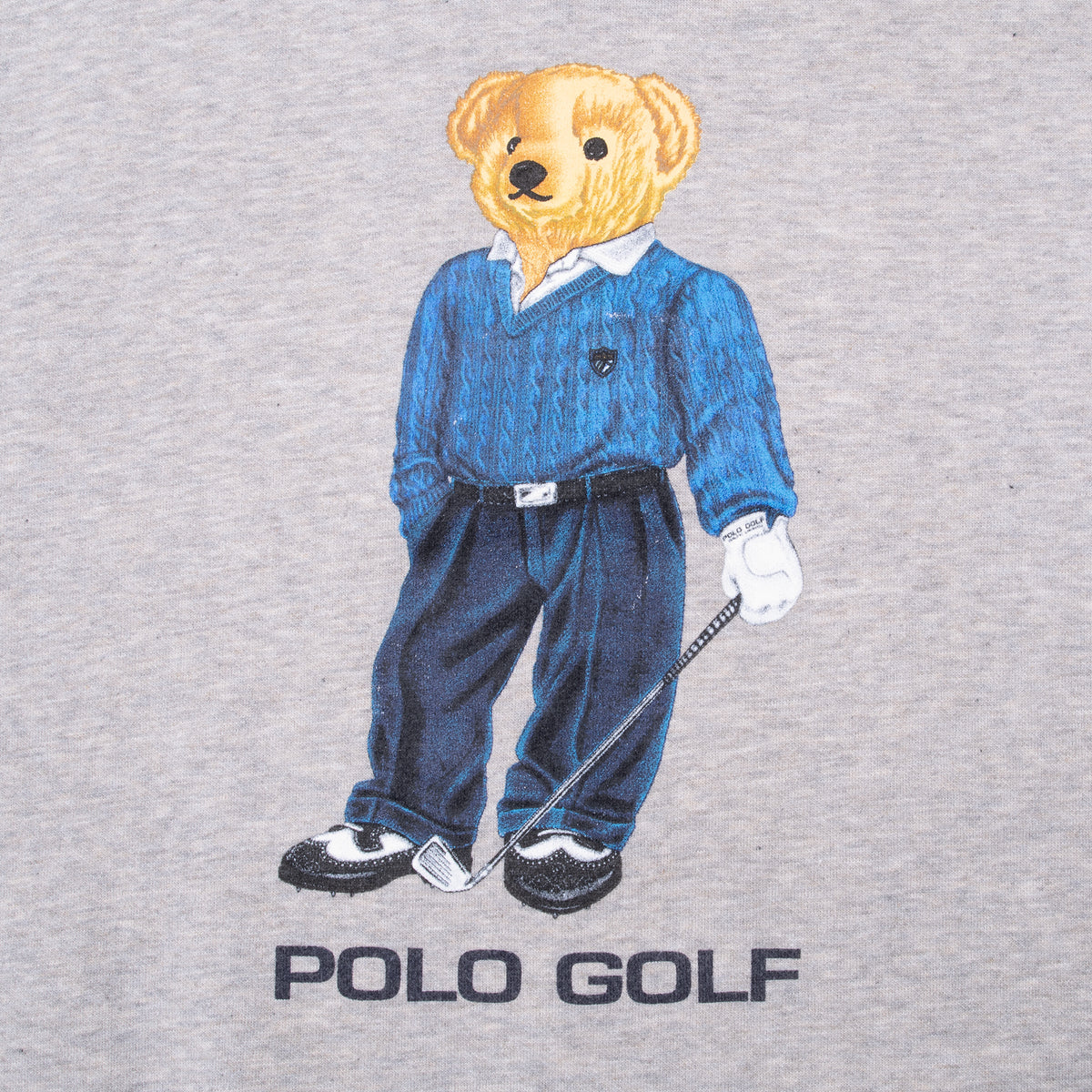 Close-up of Polo Golf teddy bear graphic holding a golf club on gray sweatshirt